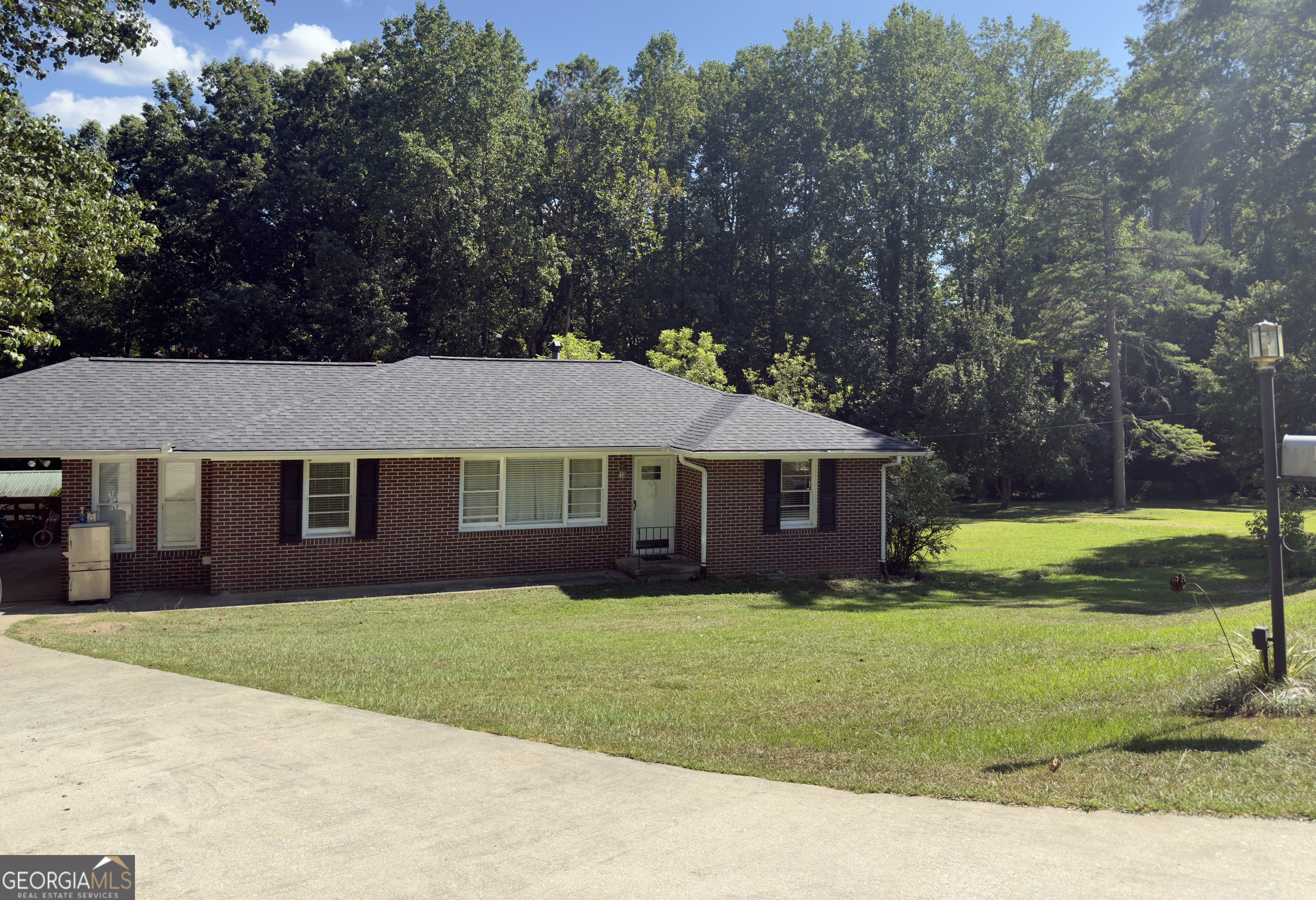 Classic 4-Sided Brick Ranch on 1.2 Acres with Creek & Bonus Buildings! This charming 4-sided brick ranch offers the perfect blend of comfort, space, and convenience! Featuring 3 bedrooms and 2 full baths, the home includes an oversized master suite with a en suite bath, plus two additional bedrooms and a full bath ideal for kids or guests. Enjoy a generous layout with a roomy kitchen offering ample cabinetry, a dedicated dining room, and a spacious family room perfect for gathering. The laundry room is conveniently located on the main floor for easy day-to-day living. Outside, this property has two combined lots totaling 1.2 acres include a creek along the back, a carport, additional parking pad, and a deck just off the kitchen-ideal for grilling or entertaining. Two outbuildings, with one powered and perfect for storage, hobbies, or a workshop. The basement features an area with a concrete floor and offers flexible space for a home gym, storage, or even a hobby area. All of this is set on a usable lot in a convenient location close to shopping, restaurants, and schools.