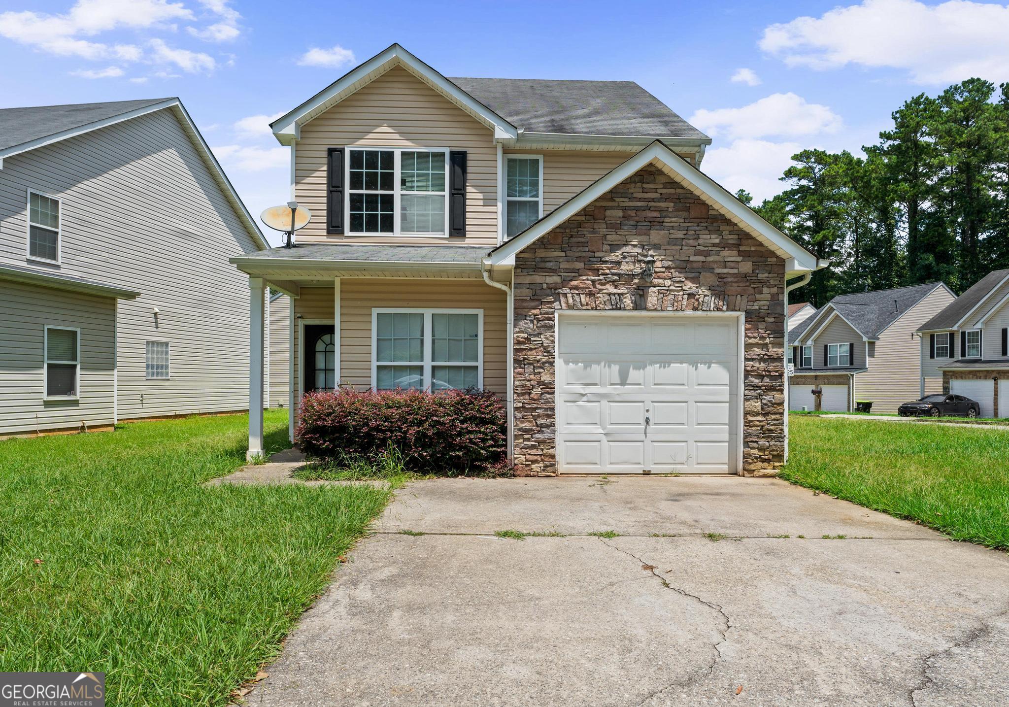 Welcome to this 4 bedroom, 2.5 bath traditional-style home situated on a corner lot in Clayton County. Located in a quiet neighborhood with sidewalks and no HOA, this home offers both charm and practicality. Step inside to find an interior just waiting for your personal touch! The inviting family room is complete with a cozy fireplace, seamlessly connected to the formal dining area and kitchen-perfect for everyday living and entertaining. The well-sized primary suite is located on the main level and features two double-door closets and a private en suite bathroom with a soaking tub and separate shower. Also on the main level, you'll find a convenient half bath and a full laundry room for added functionality. Upstairs, three additional bedrooms and a full bath provide plenty of space for family, guests, or flexible use such as a home office or hobby room. Also on the upper level is an open loft area that can serve as a second living space or bonus room. Outside, enjoy the back patio for quiet mornings or evening gatherings, and take advantage of the single-car attached garage. This home is being sold *as-is*, presenting a great opportunity for buyers to add their personal touch. Don't miss this affordable and spacious home with great bones and endless potential!