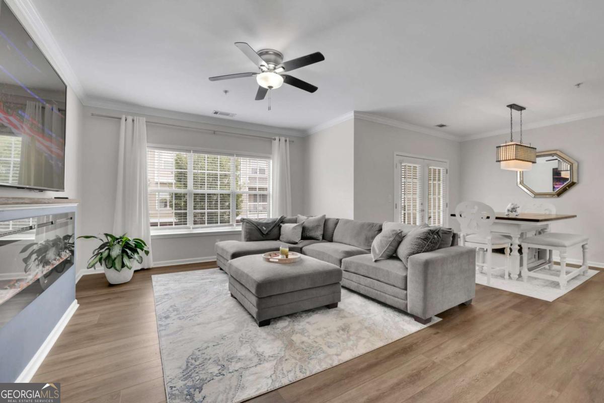 Completely updated (Townhome style) Condo in the heart of Alpharetta! Featuring an expanded kitchen with a perfect blend of white and stained wood shaker cabinets providing ample storage space. And the beveled edge marble countertops are the perfect finishing touch. Stainless Samsung appliances including an induction oven. Family room includes a custom built electric fireplace and an 85 inch mounted flatscreen television. Perfect for nights at home watching sports or a movie! Primary and secondary bathrooms include beautiful custom "comfort height" solid wood shaker cabinets, high end quartz counters with veining, new lighting, faucets and sparkling new full sized mirrors. Primary bath also includes a custom built walk-in shower with a gorgeous frameless soft close shower door. Large primary suite with vaulted ceiling and 2 generously sized secondary bedrooms. All the flooring has been updated with tile in the kitchen, bathrooms and entrance mudroom. Premium scratch and waterproof LVP in the living area and upstairs hallway.and upscale carpet and padding in bedrooms and staircases. Crown molding and neutral paint throughout. Home also boasts a new top of the line Carrier HVAC system installed by Ragsdale and still under warranty! New toilets in all 3 bathrooms. This quiet gated neighborhood is less than a mile to Avalon and the Alpha Loop with back gate access. And Just over a mile to downtown Alpharetta. Enjoy endless shopping, restaurants and entertainment just minutes away! Top Alpharetta schools!
