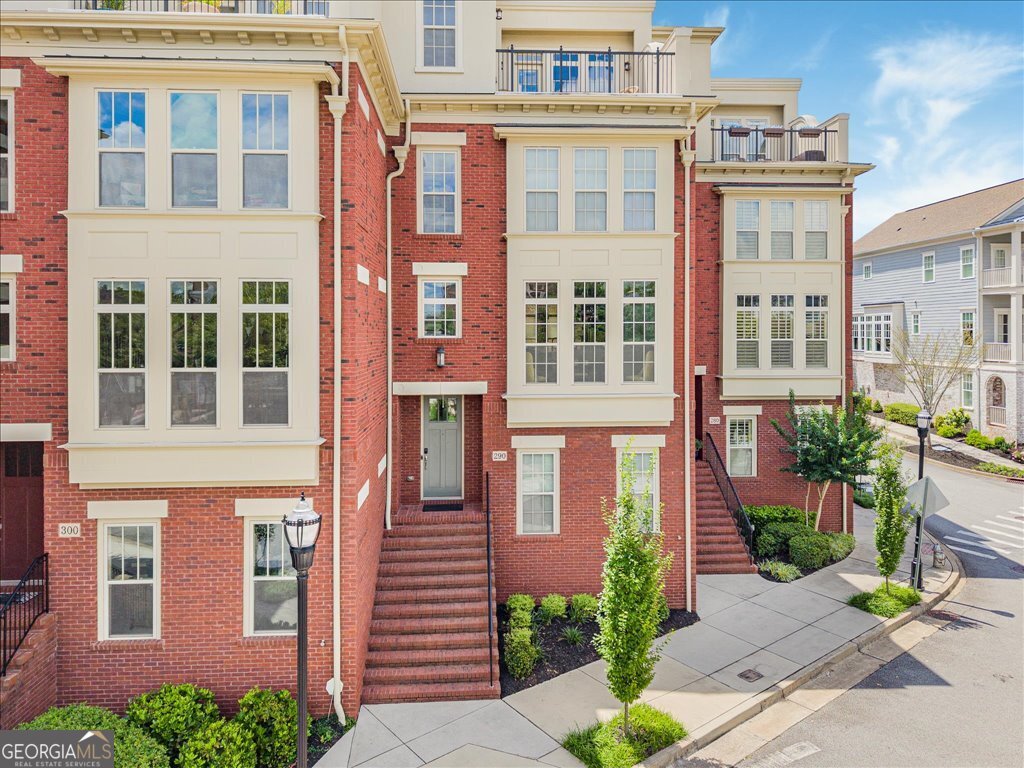 Live at the heart of it all just minutes from Marietta Square! Discover elevated townhome living in this show-stopping 4-level beauty, loaded with upgrades and unbeatable style! Welcome to this stunning 3 bedroom. 3 full and 2 half-bath townhome located just 0.1 mile from Marietta Square. This home offers the perfect blend of modern elegance, thoughtful design, and unbeatable location. Step inside to discover four spacious levels, featuring hardwood throughout and a neutral, move-in-ready palette. The main level boasts a formal dining room that flows seamlessly into an expansive chef's kitchen-complete with quartz countertops, stainless steel appliances, a large center island with breakfast bar, and open views to the great room. Enjoy your cozy evenings by the fireplace, framed by custom built ins. The upper level offers a luxurious primary suite with a fully remodeled bath, and a generous secondary bedroom with its own ensuite bath. Ascend to the rooftop level, ideal for entertaining or relaxing, featuring wet bar, media room, and access to a grilling deck & private rooftop patio with a view of Marietta Square. The terrace level includes a third bedroom and full bath - perfect for guests or a private office-as well as access to the two-car garage. Additional highlights include: Four Sides brick construction, Elevator servicing all levels, Community Swimming Pool, Meticulously maintained and in pristine condition, Refrigerator Stays, as well as Murphy Bed, Washer & Dryer. This home offers luxury, convenience, and lifestyle in one incredible package. Schedule your private tour today and experience Marietta Living at it's finest!