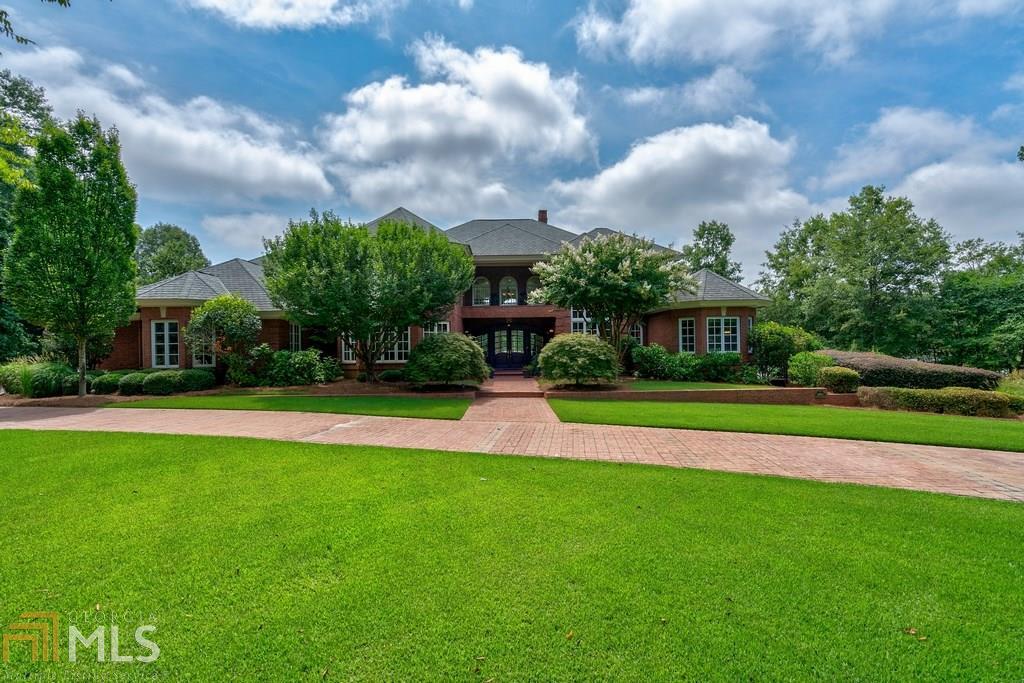 Reynolds Lake Oconee - A beautiful custom-built home situated on 2 appointed park like lake lots w/substantial Lake Oconee frontage & masonry seawall w/views of the 15th hole of the Oconee Course! Warm, open Kitchen w/Professional Viking Gas Range, Sub-zero-stainless steel refrigerator,3 Ovens,tile & wood flooring, spacious Butler's pantry, large island which opens out over the family room w/14 ft. beaded wood ceilings, fireplace, and lake views. Master bedroom has 12 ft. ceilings, heart of pine floors, two individual closets, private porch w/lake views. Large Master bathroom has two separate vanities, & high ceilings. Three bedrooms upstairs, all w/en-suite baths; two have balconies w/lake views. Downstairs living & entertaining. Elevator. Two 3 car garages