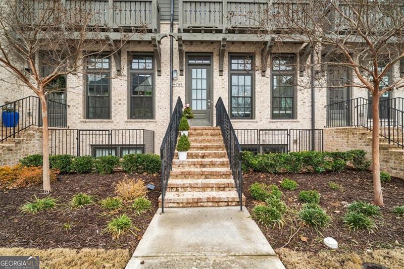 Welcome home to this modern like-new townhome nestled in a highly desirable Aria subdivision in the heart of Sandy Springs !This three-story home features open floor plan with dining room that offers lots of natural light. Modern Chef's kitchen with oversized island, gas cooktop, quartz counter tops ,beautiful backsplash and stainless appliances. Spacious living room with fireplace and hardwood floors throughout main level. Step outside to a private balcony overlooking wooded area. Main floor flows beautifully a perfect space for entertaining or hanging out with your family. Upstairs you will find a spacious master bedroom with sitting area, a luxurious bath with floor to ceiling tile and a walk-in closet. Additional bedroom with a private bath. Basement offers large bedroom a full bath and additional closet for storage. New carpet! Situated on a desirable lot that offers beautiful and private wooded area perfect for relaxation or entertaining! Two car garage and plenty of additional guest parking lots throughout the community. Aria extends an array of amenities, including two pools, a Clubhouse, a Fitness Center, a Club Room, and a 12-acre park nestled within the community. Dining and shopping options just a short stroll away in Aria Village, right across the street! Convenience is the key and this luxurious subdivision offers that and more all within this gorgeous community! Minutes from GA 400 and Marta station. A MUST SEE!!!