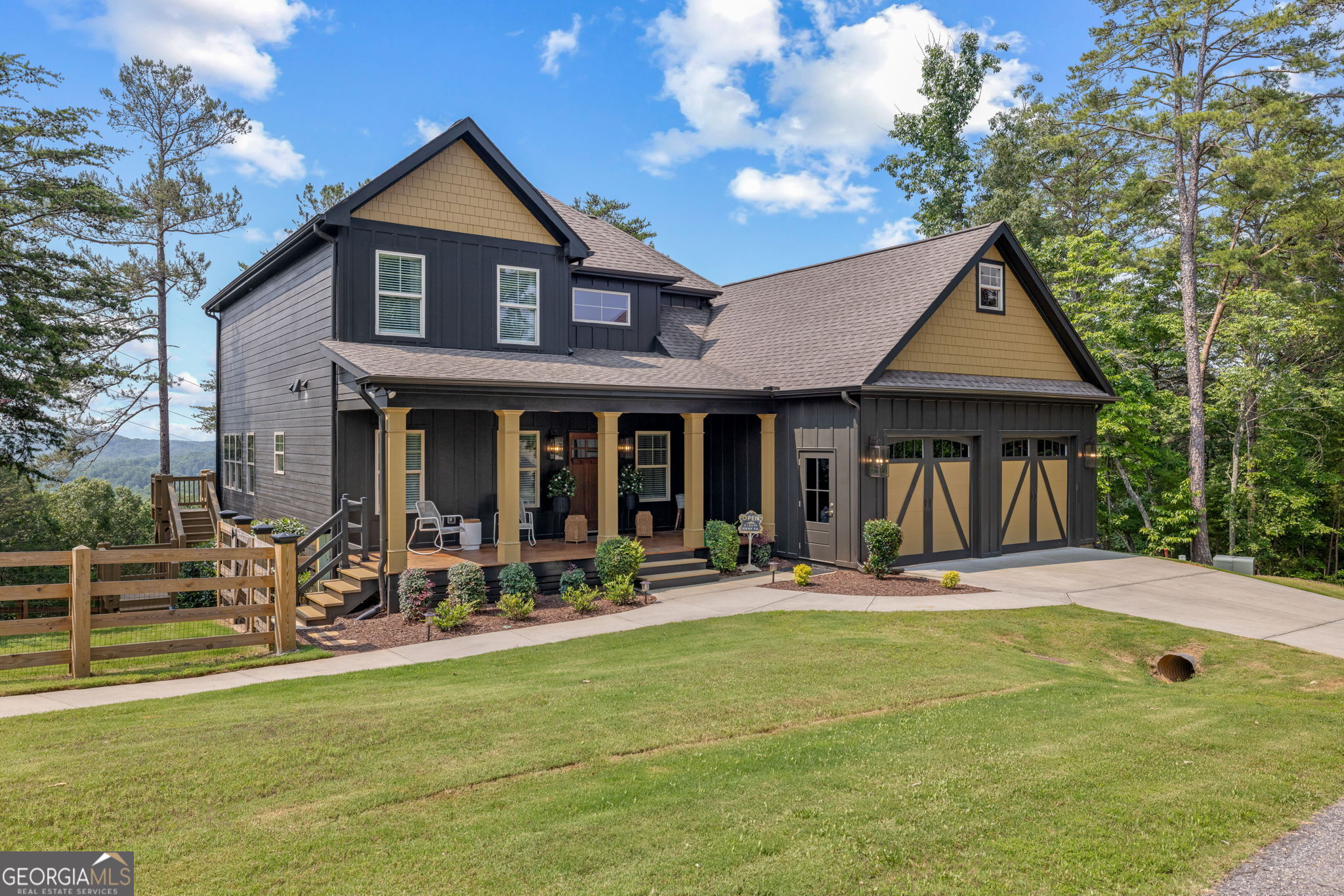 Offering a unique blend of contemporary design and gorgeous mountain views, all located in the gated community the Overlook at Crown Mountain, just minutes from the heart of Dahlonega. This newly renovated home offers an open concept main living space with mountain VIEWS from nearly every room. Upon entering, the unique monochromatic interior welcomes you inside. The kitchen crafted with function and design in mind- an oversized island offers ample workspace while still allowing guests to gather around and enjoy the setting. Exotic granite countertops line the perimeter of cabinetry while the center island offers a contrasting granite for design interest. The dining space can accommodate a long dining table overlooking the view. Just off the dining space, a seamless flow to the living room centered around a custom marble fireplace surround. Enjoy the upgraded light fixtures throughout, with dimmable lighting with nightlight feature found throughout the entire home. The primary suite on the main level is spacious with views. The en-suite showcases marble tile flooring with floor to ceiling tiled shower and separate soaking tub. Upstairs, there is a loft/flex space that serves as a second living space. The two upstairs guest bedrooms have their own private en-suites and walk in closets. On the terrace level, two additional bedrooms with private en-suites and walk in closets are inviting and ready to accommodate guests. The partially unfinished space allows for creativity or function as a workshop and storage. Newly constructed back deck additions offer the perfect space to enjoy the private setting, feeling like your nestled among the mountains and overlooking the fully fenced yard. This property offers an oversized two car garage, with additional parking pad, positioned on a quiet cul-de-sac. Just 2.5 miles from the Dahlonega Square with shopping and dining, University of North Georgia, and convenient to GA 400 access.