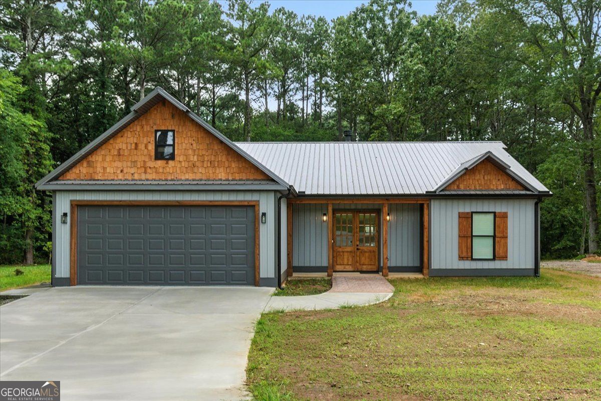 Welcome home to this custom built stepless ranch home nestled on 2 acres. Enjoy the gourmet kitchen with gas cooktop, pot filler, 2 dishwashers that opens to the enormous dining room with another fireplace. This home is a split bedroom plan. The living room has all the cozy feels with another beautiful fireplace. The large outdoor patio is covered with a veranda perfect for all the entertaining. This home also has full RV hook ups (power, water, and sewage) Metal roof and siding boast maintenance free living for years to come. Tankless water heater and so much more! No subdivision, No HOA! Seller is also leaving all appliances, washer and dryer, and all mounted tv's.