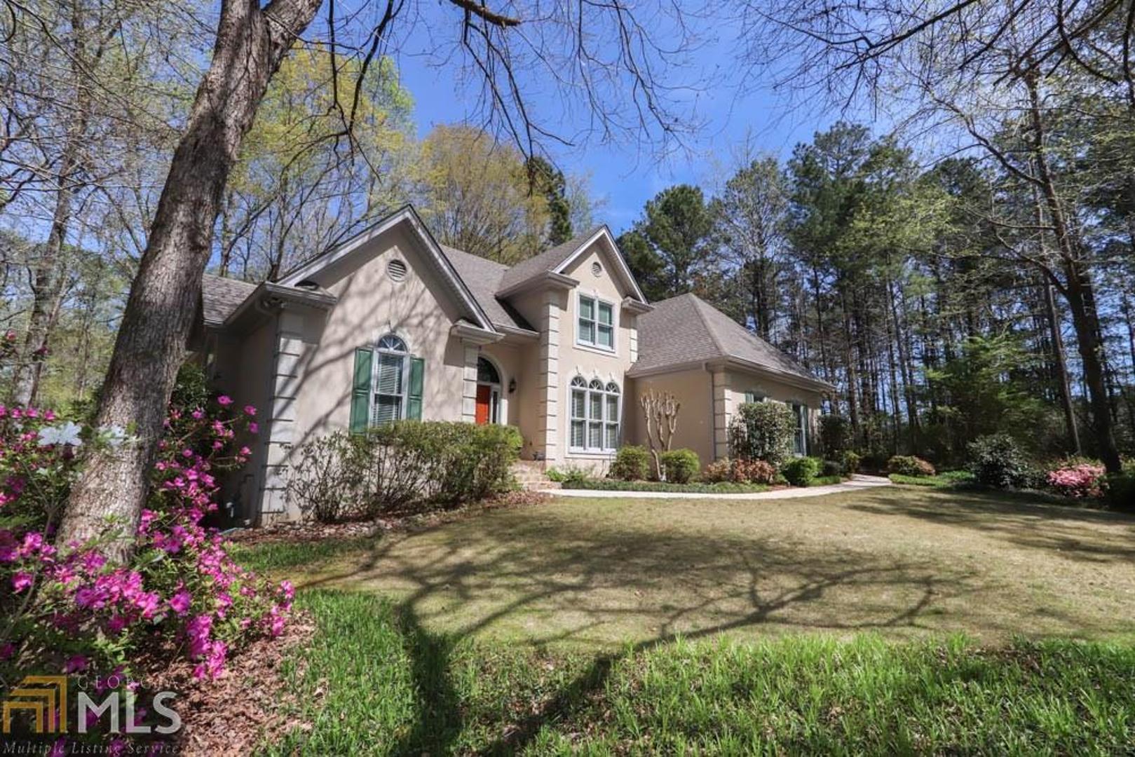 Beautiful Custom Home on 6th hole of the Newnan Country Club Golf Course in Exceptional Golfview! Gardener's Paradise in a Serene Setting! Home includes Granite kitchen counters w/hdwd floors, bkfst bar & walk-in pantry. Keeping room w/gas f/p & Plantation shutters! Vaulted family room w/gas f/p & wall of windows w/view of lush back yard & golf course! Master on main w/trey ceiling. Tiled master bath w/dbl vanity, jetted tub, separate shower & walk-in closet! Formal dining room w/hdwd floors. 3 bedrms upstairs & 2 full baths. Walk-in attic for storage. Fenced side yard. Irrigation system. Full u/f basmnt. Upgraded Pella windows, Roof and HVACs. Close to Cancer Center/ Hospital/Great Shopping/I-85 access, Atlanta airport and under 50 Minutes to Downtown ATL.
