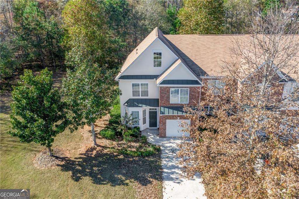 Welcome to 374 Saint Claire Drive, an end-unit townhome located in the desirable Saint Claire community in Alpharetta. This spacious 4-bedroom, 2.5-bathroom home offers 2,090 sq ft of thoughtfully designed living space, featuring newer hardwood floors on the main level, tile flooring in the sunroom, and brand-new carpet upstairs. The updated kitchen includes stained cabinets, a pantry with a spice rack, solid surface countertops, and newer appliances including a refrigerator, gas range, microwave, dishwasher, and disposal. Enjoy a cozy living area with a fireplace, a separate dining room, and a one-car garage with a long driveway for ample parking. The primary suite features a double vanity, soaking tub, and separate shower. Freshly painted throughout, this home is located just minutes from Halcyon, The Collection at Forsyth, the Big Creek Greenway, and parks. Zoned for top-rated Denmark High School, the community offers amenities such as tennis courts and a swim team, making it ideal for active lifestyles