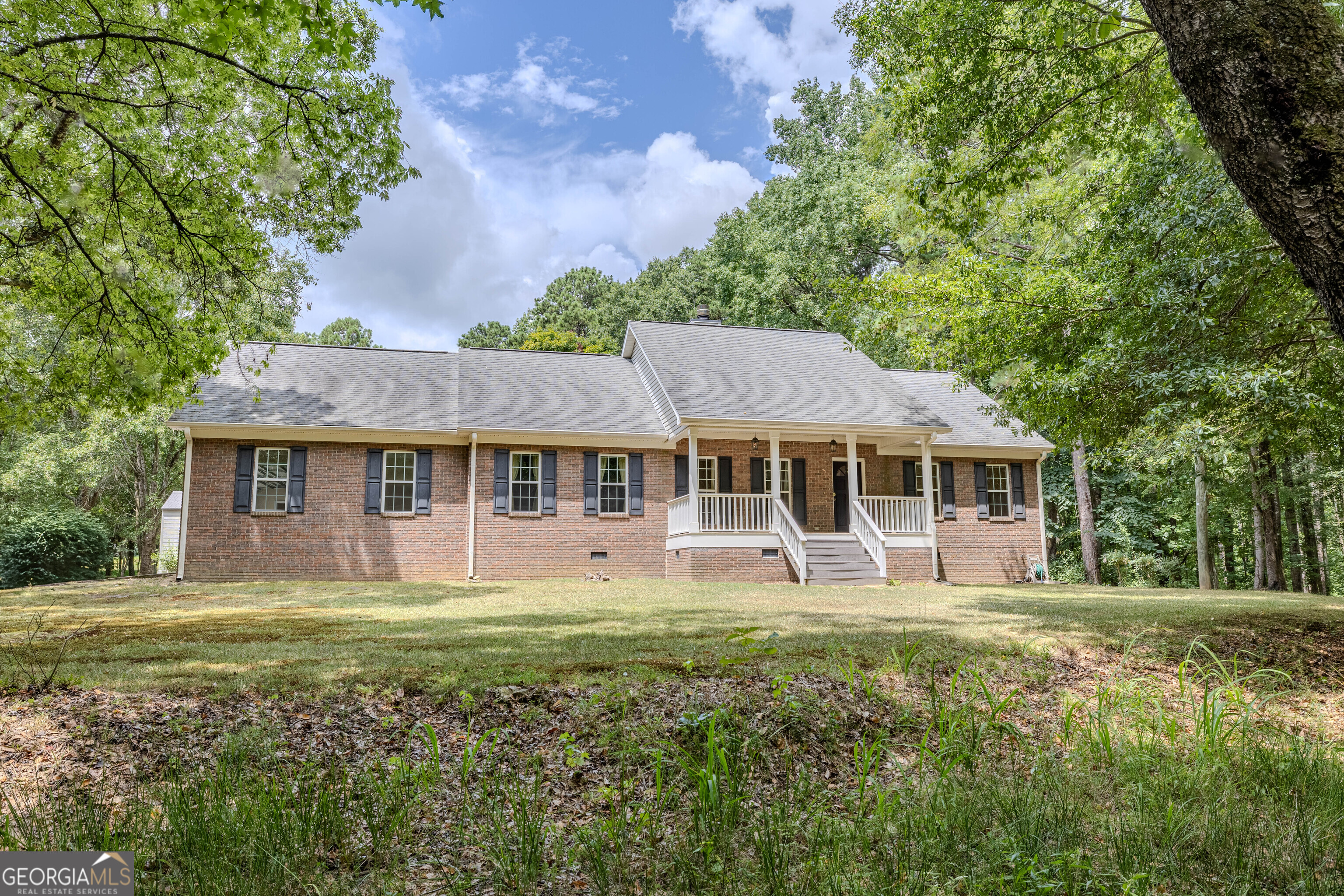 AMAZING 7-acre private level lot in Model district with a 4-sided brick house. Set off the street and wooded in front, this is a picturesque property! This well-maintained, three bedroom and two bath home is offered for sale for the first time! One level with a den with wood burning fireplace, dining room, kitchen with keeping room, and the SUNROOM on the back of the house with pasture views is the highlight! The home has been inspected and a few small repairs completed! The outbuilding and a generator stay with the property. ADDITIONALLY - the street side, small grey home at the front of the property on 3 acres, is going to be offered for sale within a year and buyers can choose to have the first right of refusal. This updated, well-kept cottage would be an ideal spot for aging parents, a fantastic rental, or a guesthouse. This is TRULY A SPECIAL PLACE!