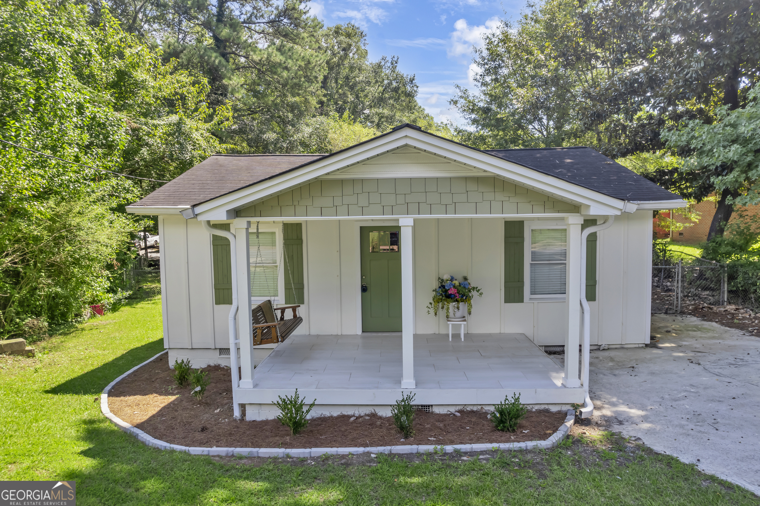 Welcome Home! Tucked away on a quiet street in desirable Marietta, this fully renovated 2-bedroom, 2-bathroom home blends timeless character with high- end, contemporary upgrades. Set on a private lot with a fenced-in back yard, the home has been completely transformed inside and out to offer open, modern living with quality craftsmanship throughout. A reimagined floor plan creates effortless flow, enhancing natural light and promoting a more open, livable main living space. The brand-new kitchen is the heart of the home, featuring an oversized island, quartz countertops, all-new custom cabinetry, stainless steel appliances, and modern lighting-a sleek, functional space designed to impress. Both bathrooms have been upgraded with the original half-bath expanded into a full second bathroom boasting contemporary tile flooring, stylish vanities, and premium fixtures. Throughout the home, you'll find refinished hardwood floors, new lighting, and fresh paint inside and out, offering a clean and cohesive aesthetic. Exterior upgrades include new HardiPlank siding, a refreshed front porch with a porch swing and a new entry door, and a refinished back deck, perfect for relaxing or entertaining. The private backyard adds to the home's appeal, offering quiet outdoor space within walking distance from Marietta Square, Kennestone Hospital, Elizabeth Porter Park, and Historic Marietta attractions and dining.