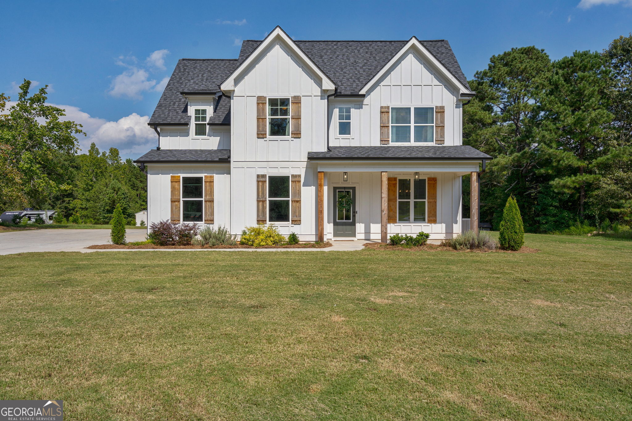 If you've been dreaming of wide-open space and farmhouse charm, this one's for you! Sitting on over 5 acres with no HOA, this beautiful 4-bedroom, 3.5-bath home has all the space and comfort you've been looking for. Step inside and you'll find a welcoming foyer with a handy office space right up front-perfect for working from home or keeping things organized. The open layout makes it easy to stay connected, with a cozy living room featuring a wood-burning fireplace and built-in shelving. The kitchen is a true gathering spot that has a big island with a breakfast bar, stainless steel appliances, gorgeous backsplash, and a walk-in pantry to keep everything tucked away. Just off the kitchen, the dining nook opens up to a covered patio-great for cookouts, morning coffee, or just enjoying the view. Upstairs, all four bedrooms are together, including a roomy primary suite with trey ceilings. The private bath has double vanities, a shower, and a relaxing garden tub-perfect after a long day. One of the secondary bedrooms has its own private bathroom while the other two bedrooms share a jack & jill bathroom. With tons of natural light, recessed lighting, and farmhouse touches like cedar posts and shutters, this home feels both warm and stylish. And outside? You've got acres to spread out, explore, and make your own. The backyard is perfect place for a pool! Come see this one-you'll fall in love with the space, the style, and the possibilities!