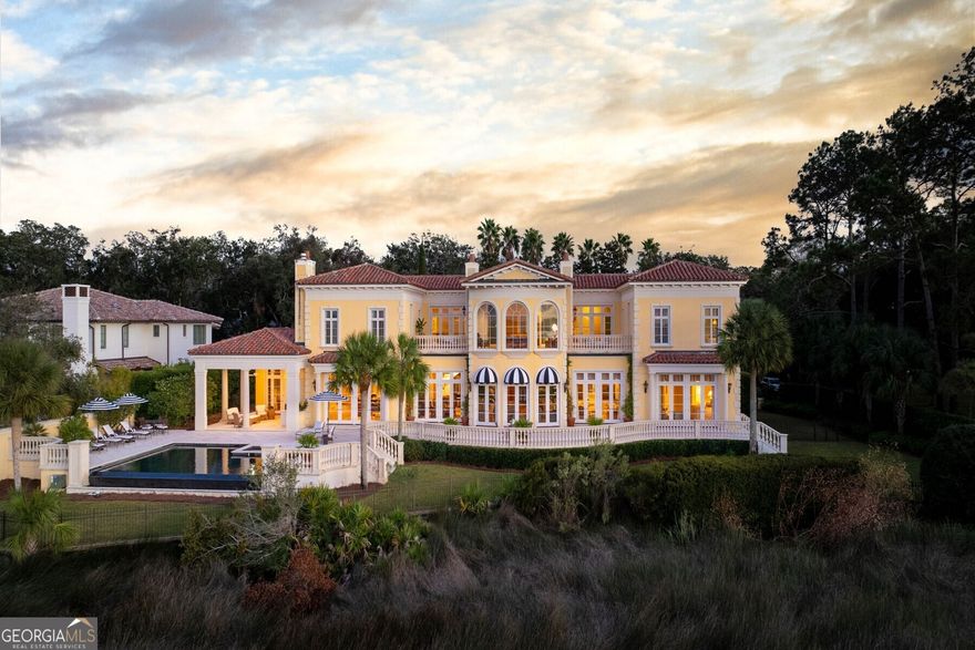 "Villa Measured", Cottage 509 has one of the few and finest Marsh and Riverfront Views on Sea Island. Enjoy the ultimate in privacy, luxury, and Style in one of the South's most magnificent private estates. This Neoclassical Style home stands apart as an architectural masterpiece. Defined by top-quality craftsmanship this exquisite home blends Old World elements with modern-day appointments creating inviting spaces for relaxing and entertaining. The driveway to Villa Measured is aggregate stone and concrete. The Cottage was constructed on 35-50 foot pilings, and built with load-bearing masonry walls, Ludowici terra-cotta clay roof tiles, stone balusters, precast concrete floor panels, and Medici yellow stucco. There are 12-foot ceilings, limestone columns, Ron Batton custom millwork, and copper finishings. There is lightning protection on this cottage.  It was designed with Musee Rodin's home in Paris, France in mind. The views from the upper and lower loggia areas overlook a vanishing edge pool with a 7-foot depth and hot tub. The additional 1100 sq ft Guest accommodations are easily accessed from the second floor and the main floor of the Cottage. The custom front gate, front door, and interior handrails were all designed by Jerry Grice.  As you enter the front Portico to the terra-cotta tiled foyer and limestone columns you look straight through the house to the marsh and riverfront. There are 3 interior fireplaces, 2 gas, and one wood burning. The mantles are Chesneys.  The Fourth fireplace is in the outside loggia and is wood-burning.  Two Interior "Fire Sculptures" were designed, handmade, and numbered by Cathy Burkman, an artist in London, and designed to softly crackle and pop to simulate a sense of light, sound, and feel. The spacious living room and dining room open up to a great room connected to the kitchen and vaulted breakfast room.  The South primary wing has a separate Study with custom millwork and bookcases, his and her dressing areas, and an exercise room. The double doors from the Primary bedroom open out to the marsh and limestone terrace. The second floor has 5 bedrooms, and two limestone terraces separated by the Marsh room. There is a tennis rebound court on site.  Dock application permitting has been initiated and should be forthcoming. The finished floor elevation is 16 1/2 feet.