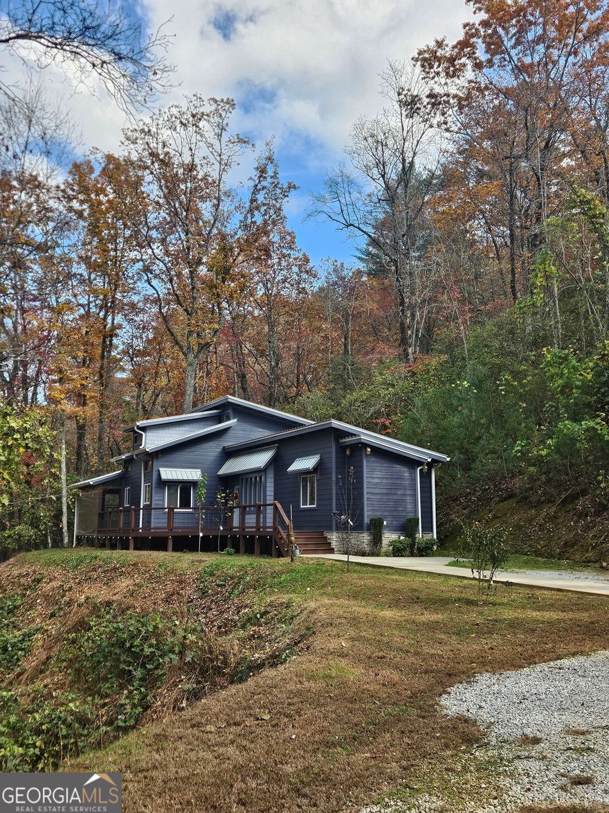 Professional Photos Coming Soon!!!! Distinguished move-in ready three-bedroom family residence. This house needs nothing!!!!  Presenting an exceptional opportunity to acquire this meticulously maintained and well-kept three-bedroom, two-bathroom single-family residence, offering an exemplary blend of comfort, sophistication, and practicality. A modern farmhouse home that was built in 2016 with Hardie board siding and metal roofing and is as custom as they come!!!! Situated in a highly desirable location, just minutes to downtown Clayton. The home seamlessly integrates contemporary enhancements with timeless elegance with Quartz countertops, tongue and groove ceilings, custom tile showers, barn doors, and an electric fireplace with remote. Spacious, Modernized, and Move-In Ready in a convenient location! Brand new kitchen featuring plenty of storage and counterspace. Freshly painted and including a custom designed 40x30 shed with and 18-foot-high center that has water and electricity with plenty of amperage to support an electric vehicle charger. Bring your toys as there is room to store it all here with a custom-made tote storage rack.  It even includes a man cave, with a spot to already in place for a wood stove to keep you warm all winter long.  Have dogs? There is a dog run in the back yard! Covered and screened back deck for you to enjoy the seasonal mountain views. It even has removable clear vinyl to keep in the heat during winter if you wish. This is located within city limits of Clayton making it easy to use as a vacation rental.