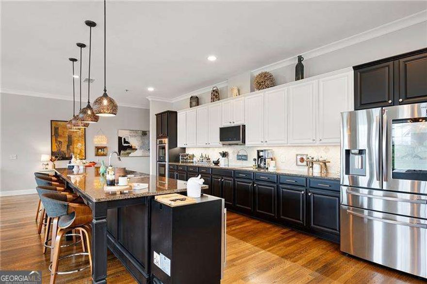 Welcome Home to the only Penthouses in this building. End Unit goes from the front of the building to the back. Sit out balcony on the front overlooking City of Woodstock & walk out balcony off the back of the unit overlooking Mountains. This is clearly an entertainment unit a 12ft x 4ft island in the chefs kitchen with walk-in pantry. Private Master Suite w/Master closet 15ft by 6ft. Master bath has separate shower & tub to relax in with two vanities. Guest bedroom is also a private suite with full bath and oversized room and closet. Lots of storage space. This Condo has the WOW Factor!!! End Unit Experience elevated living in this one-of-a-kind penthouse, the only one in the building and a true top floor end-unit that spans from front to back - offering uninterrupted views in both directions. Start your day with sunrise on the rear walk-out balcony facing the peaceful mountains, and unwind with sunset views from the front balcony overlooking the vibrant City of Woodstock. This luxury condo is packed with over $100,000 in high-end upgrades and offers a lifestyle that's second to none in the heart of downtown Woodstock. With abundant storage, upgraded lighting, and thoughtful design details, this home has it all.  Designed for entertaining, the open-concept living space features a chef's kitchen with a massive 12' x 4' island, walk-in pantry, and premium finishes throughout. The private primary suite is a true retreat, complete with a spacious 15' x 6' walk-in closet and a spa-inspired bath that includes a soaking tub, separate shower, and dual vanities. The guest bedroom is also a private suite, offering a full bath and an oversized closet, perfect for guests or a home office.  Located just steps away from Woodstock's amphitheater, shops, restaurants, and Greenprint Trails, this penthouse puts you at the center of it all. Voted one of Money Magazine's Top 50 Places to Live, Woodstock offers a vibrant, walkable community - and this is your chance to live right in the middle of it. This penthouse truly delivers the WOW factor - don't miss it!