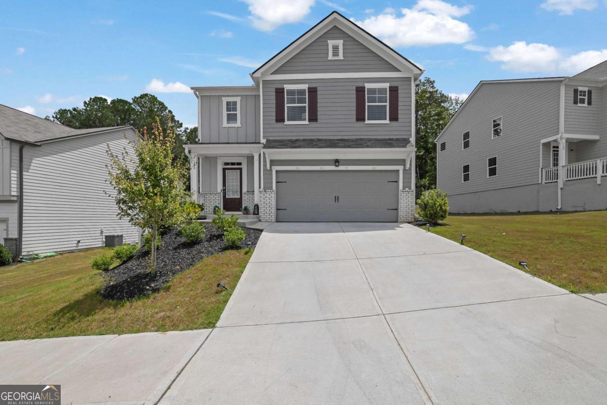 Stunning Home with Mountain Views, Resort-Style Amenities, and Ideal Location! Discover the perfect blend of natural beauty, modern design, and unbeatable convenience in this gorgeous 5-bedroom, 3-bathroom Robie floor plan located in sought-after Etowah Preserve. Nestled at the foothills of the North Georgia Mountains and bordered by Dawson Forest on two sides, this home offers breathtaking mountain views and direct access to miles of outdoor adventure-including hiking, fishing, kayaking, horseback riding, and more. The Etowah River lies just to the east, making this a nature lover's dream. Step inside to a designer kitchen featuring white shaker-style cabinetry with soft-close doors, granite countertops, stainless steel appliances, and a walk-in pantry. The large chef's island overlooks a spacious open-concept great room, ideal for entertaining or everyday living. RevWood laminate flooring on the main level (excluding bedrooms) ensures style and durability with low maintenance. Upstairs, a generous loft provides extra living space, while the primary suite features a deluxe bathroom with thoughtful upgrades. With five total bedrooms, there's room for everyone. Etowah Preserve offers exceptional resort-style amenities including a Jr. Olympic swimming pool, splash pool, tennis courts, pickleball, clubhouse, and playground. All of this is just minutes from GA-400, Lake Lanier, North Georgia Premium Outlets, and an array of shopping and dining options. Don't miss your chance to own a home in this exceptional community where luxury meets lifestyle!