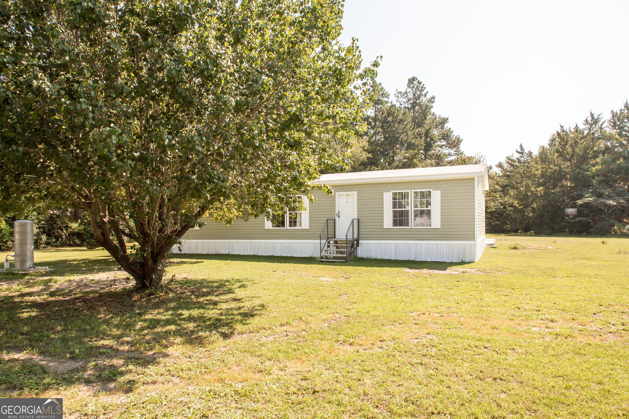 Located off of the Brantley county side of Central Ave, This spacious 2021 double wide has been recently moved to its 1-acre lot and is ready for new owners. Offering 1,568 square feet, this home features 3 bedrooms and 2 full bathrooms, providing plenty of space for family, guests, or a home office. Inside, you'll find neutral colors throughout, an open-concept living and dining area, and a generous kitchen perfect for daily life and entertaining. The property includes a new well, offering peace of mind and reliable water service. Outside, enjoy the large yard with mature plantings and plenty of room for a garden, play area, or outdoor gatherings. Experience comfortable country living with modern conveniences