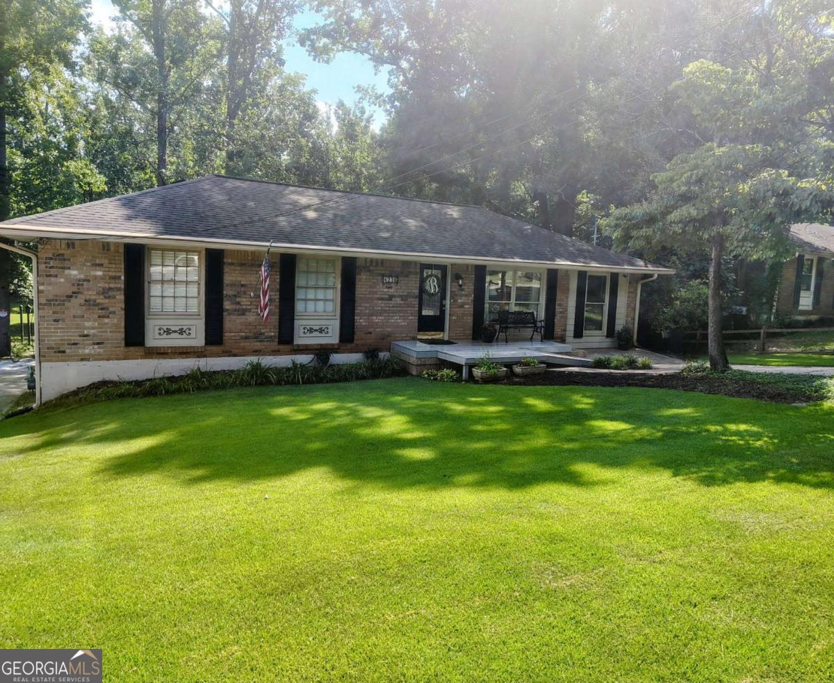 This beautiful brick ranch is full of charm. Cozy living room and large family room with a separate dining room provides plenty of room for entertaining. Boasts a beautiful open floor plan with tons of upgrades to include Corian countertops, pendant lights, recessed lighting, hardwood floors, neutral paint. Large walk-in pantry. The best part is the large stunning yard that is perfect for gatherings or quiet evenings. Small creek called Butternut creek runs along the back yard. Enjoy your view from the serenity of the large screened in porch, the perfect place to unwind. Basement apartment has two rooms and full bathroom with kitchen area. Large unfinished area below for workshop or storage. Also features two driveways for parking and room for boat and/or RV. No HOA. This home is within minutes from the East-West Connector, unbeatable convenience to shopping, dining, and more. Enjoy quick access to downtown Smyrna (17 minutes), downtown Vinings (20 minutes), and major highways including I-20 and I-75 (both within 15 minutes). Truly a must see!