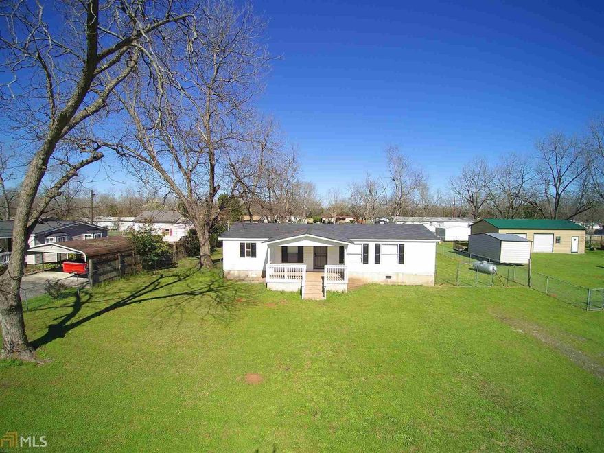 This is an adorable, clean, move-in ready manufactured home on a nice, level lot off Hwy 41 in Byron.  Huge covered front porch, new a/c, roof in good shape, plumbing in good shape (owner made repairs/improvements to both) and new faucets. Refrigerator stays!  Fireplace, 3br, 2 ba, split floor plan and amazing amount of cabinets in the kitchen.