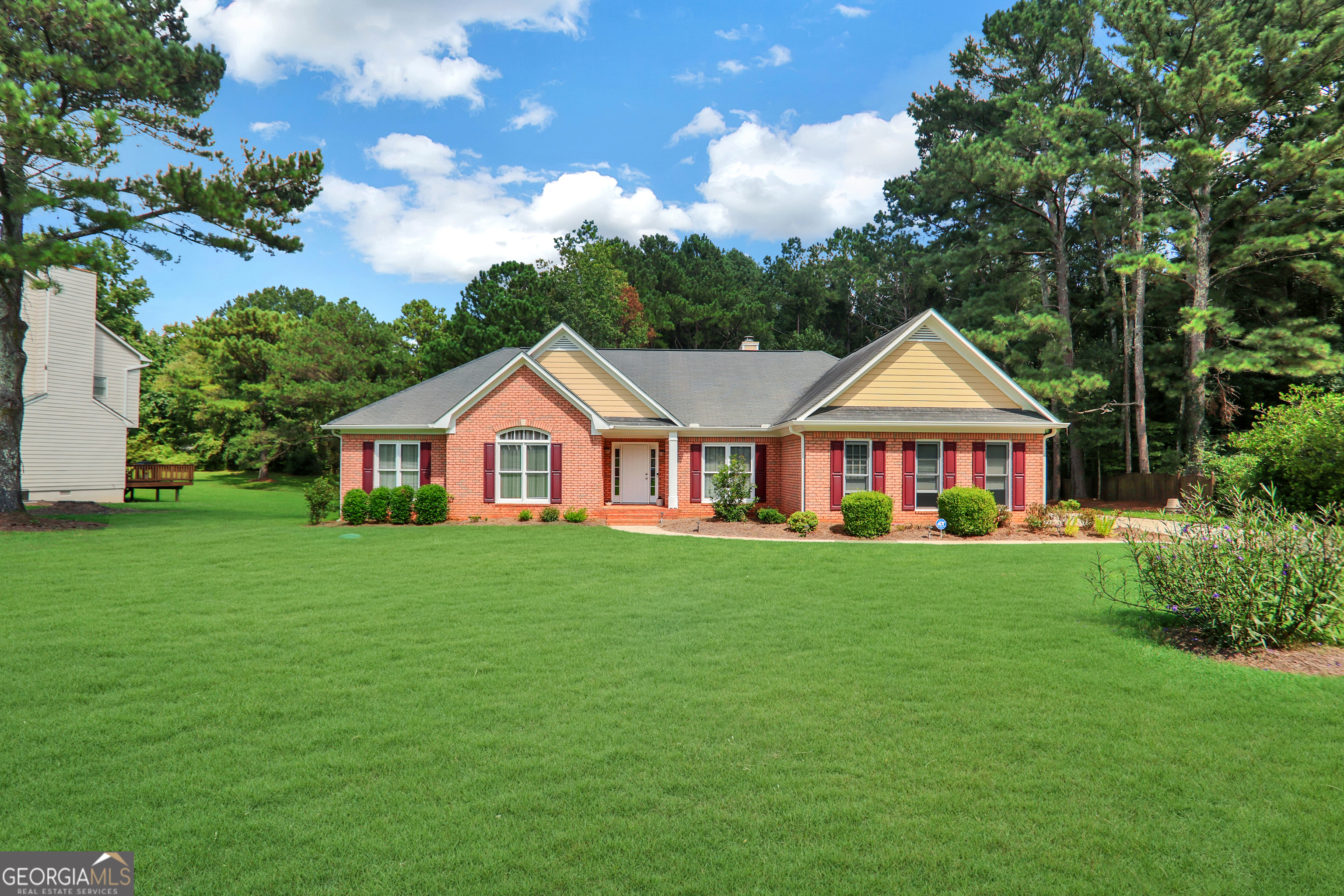 Welcome to 2056 Rosemont Court - an immaculate and beautifully maintained ranch-style John Weiland built home in the highly sought-after Fairfield subdivision of Jonesboro, GA. This elegant residence blends timeless design with quality craftsmanship, offering the ease of true one-story living in a peaceful setting. Step inside to find a bright, open floor plan featuring spacious living areas, high ceilings, and abundant natural light. The formal living and dining rooms provide an inviting space for entertaining, while the family room with fireplace creates a cozy spot to relax. The updated kitchen has ample cabinetry, white countertops, and a dining area overlooking the backyard. The generous primary suite features vaulted ceilings, his-and-hers closets, and spa-like bath with soaking tub and separate shower. Additional bedrooms are well-sized with plenty of storage all conveniently located on one level for everyday ease. Enjoy outdoor living on the private back deck, perfect for summer evenings or weekend gatherings. The landscaped yard offers beauty and low maintenance with convenient attached two car garage. Located in a friendly community known for its tree-lined streets and swim/tennis amenities, you'll have easy access to schools, shopping, dining, and major highways. Don't miss your chance to own this quality-built ranch in one of Jonesboro's most desirable neighborhoods!