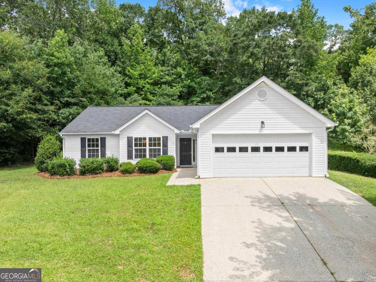 This 3-bedroom, 2-bathroom home is located in the quiet, established Flanagan Mill Estates community, where large lots and no HOA fees give you extra flexibility and privacy. Inside, you'll find all-new luxury vinyl plank flooring throughout, freshly painted walls and trim, and updated light fixtures in every room. The kitchen features newer stainless steel appliances and an upgraded sink, while both bathrooms have been refreshed with new vanities and flooring. The spacious primary suite includes a walk-in closet and a large ensuite with a double vanity, soaking tub, and separate shower. Two additional bedrooms, a full guest bath, laundry room, and a 2-car garage provide a practical layout that fits a variety of needs. The private backyard offers plenty of room to relax, garden, or entertain. The home is USDA loan eligible and tucked away in a peaceful neighborhood, yet just minutes from schools, shopping, and dining. Set on over a half acre, this move-in-ready property is ideal for buyers looking for space, updates, and a quiet setting without the restrictions of a HOA.