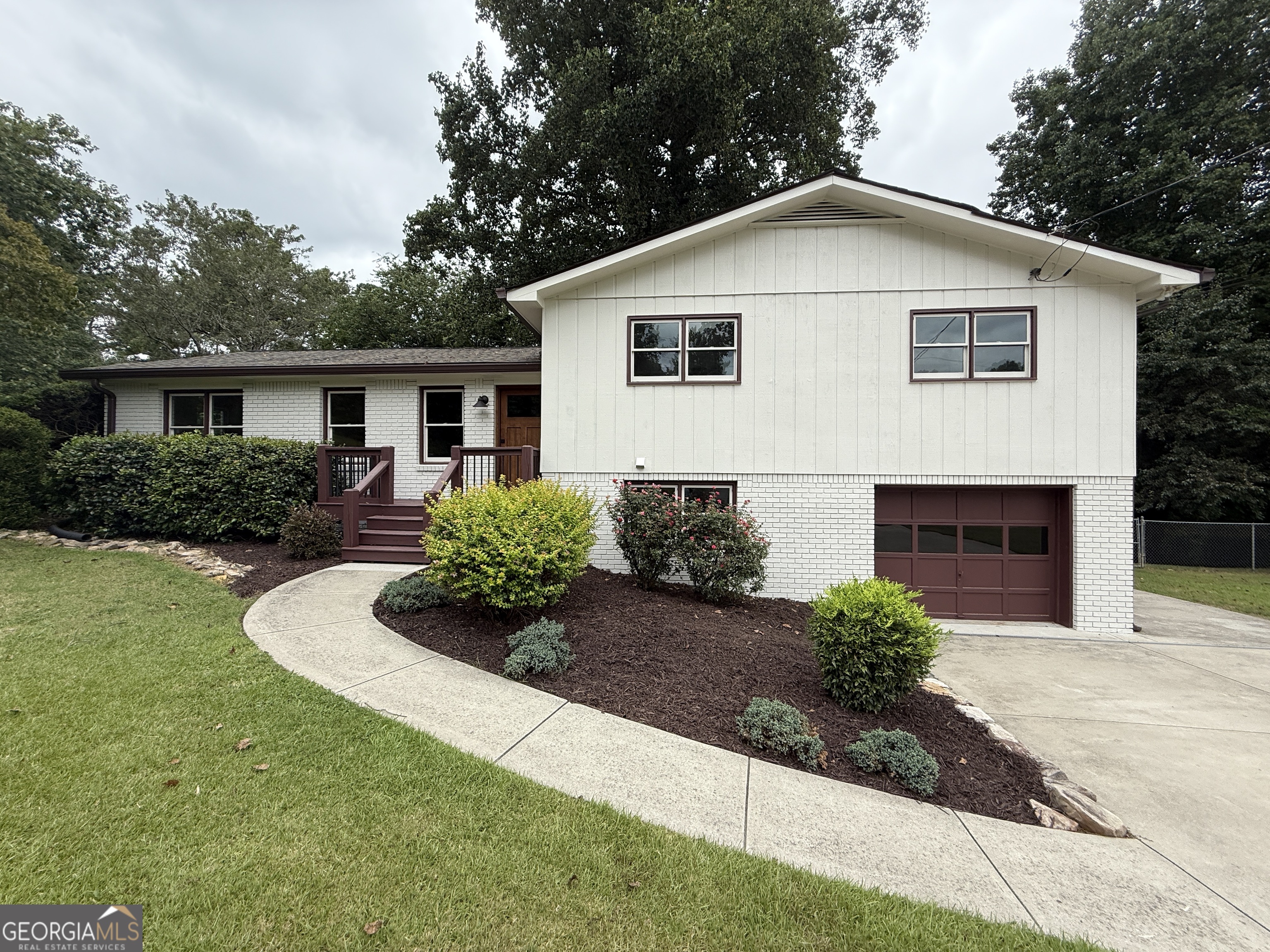 Beautifully updated home on a large private lot. Open plan with a vaulted great room featuring wood beams, a ceiling fan, and a fireplace. Recently renovated farmhouse style kitchen w/ custom cabinetry, tile backsplash, solid surface counters, and stainless steel appliances.