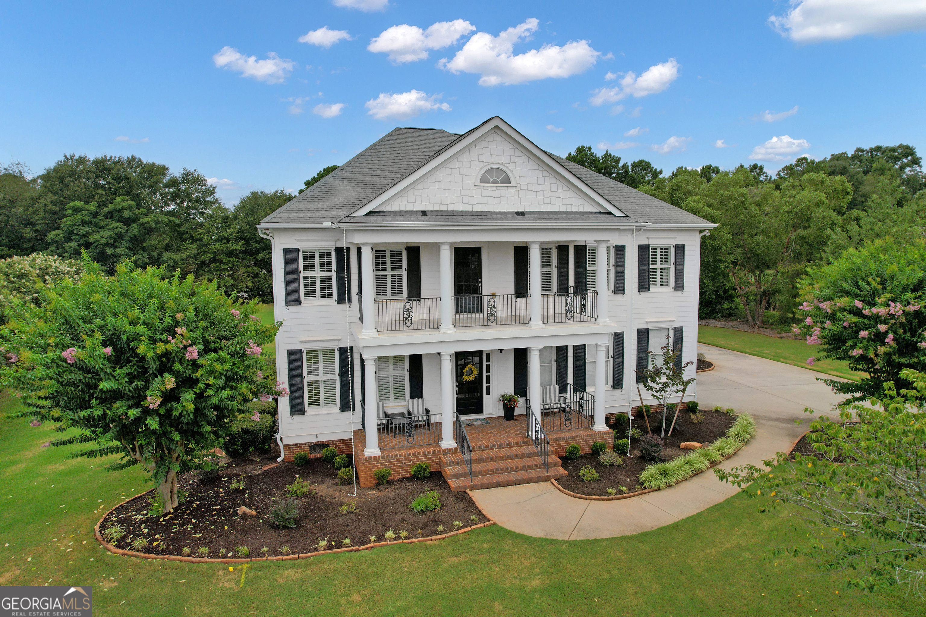 Southern Charm Meets Modern Luxury in Sought-After Maple Shade!!! Set on a rare 1.2-acre flat lot in the prestigious Maple Shade subdivision, this beautifully upgraded Colonial-style home with hardi-plank siding offers timeless curb appeal and modern conveniences in one of Peachtree City's highest elevation points. Just minutes from Hartsfield-Jackson Airport, Trilith Studios, the U.S. Soccer Federation Training Center, and The Avenue Peachtree City, this home provides both privacy and premier access. The open and thoughtfully designed floor plan welcomes you with hardwood floors throughout the main level, rich crown molding, plantation shutters, and custom trim work. The gourmet chef's kitchen features granite countertops, custom cabinetry, under-cabinet lighting, 4-burner gas cooktop, double convection ovens, Bosch refrigerator (2024), large island, and a sink overlooking the peaceful backyard. It opens seamlessly into the spacious family room with a gas-start, wood-burning stacked stone fireplace, built-in cabinetry, and recessed lighting-ideal for entertaining or relaxing. A formal dining room with wainscoting seats eight comfortably, while a private office/den with French doors and a coffered ceiling makes working from home a breeze. Upstairs, a large loft/media room with built-ins leads to the upper balcony and offers an additional gathering space. The second floor boasts four spacious bedrooms with ceiling fans and three full bathrooms. The luxurious owner's suite includes a sitting area, trey ceiling, double-door entry, dual walk-in closets with built-ins, and a spa-like bath with jetted tub, frameless glass shower, and dual vanities. Two bedrooms share a Jack-and-Jill bath, while the fourth has its own en-suite-perfect for guests or teens. The upstairs laundry room with built-ins and retractable ironing board provides easy access. Ample storage is provided with two large linen closets and pull-down attic access as well. Enjoy year-round outdoor living with a vaulted screened-in porch overlooking a saltwater pool with a new liner and salt cell (2025), 9-ft depth with diving board, and smart timer/app-controlled pump and lighting. Additional features include a golf cart garage with tiled, climate-controlled half bath, irrigation system with 12 zones, invisible fence, Rinnai tankless water heater, and an insulated 2-car garage with overhead storage and a brand-new garage door (2024). Zoned for top Fayette County schools and directly connected to Peachtree City's golf cart path system, this home is a rare opportunity to enjoy luxury, space, and community in one of the Southside's most coveted neighborhoods.