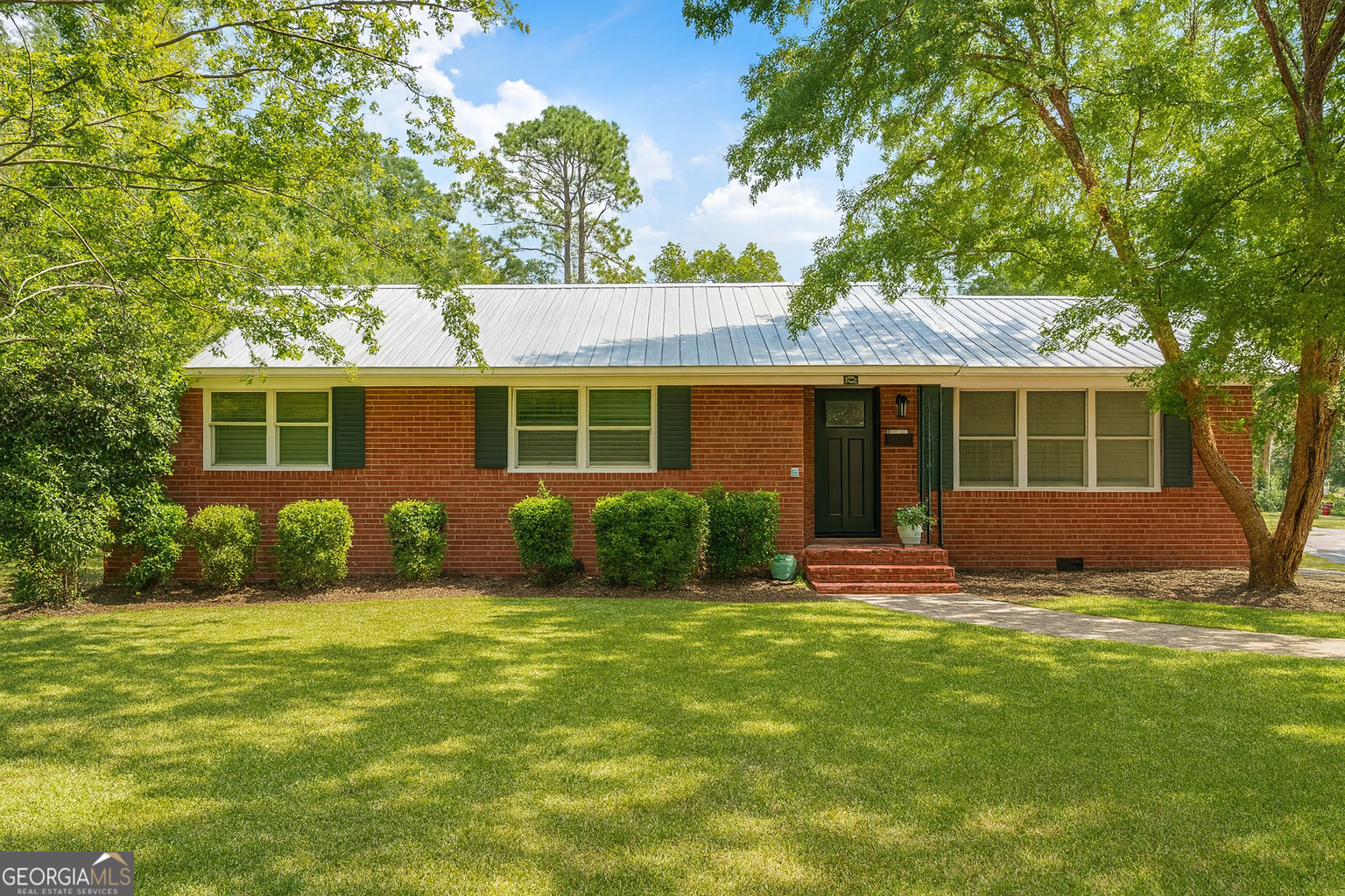 Experience refined living in this beautifully renovated brick three-bedroom, two-bath home located in the desirable Cherokee Heights community. Spanning over 1,500 square feet, this residence blends timeless character with modern sophistication. Step inside to discover fresh paint throughout, new laminate flooring, stylish ceiling fans, elegant light fixtures, and a stunning energy-efficient entry with a brand new Therma-Tru door that sets the tone for the entire home. The coastal-inspired kitchen offers an abundant amount of cabinetry and a spacious eat-in area that flows seamlessly into an open living and dining combination, perfect for entertaining. Both bathrooms have been tastefully remodeled, with the primary suite showcasing a spa-style shower complete with a built-in convenience bench. This home is free of carpet for easy, low-maintenance elegance. Every major detail has already been taken care of, including brand new appliances with a five-year warranty, a new HVAC system installed in December 2025, and a one-year-old metal roof. Outside, enjoy your private oasis with a brand-new vinyl privacy fence, a newly built storage shed, and an oversized covered carport accommodating up to three vehicles. The expansive backyard is ideal for gatherings, pets, or simply relaxing in your own retreat. With its prime location close to shopping and dining, this turnkey home delivers modern style, convenience, and peace of mind-ready for its new owner to move right in.