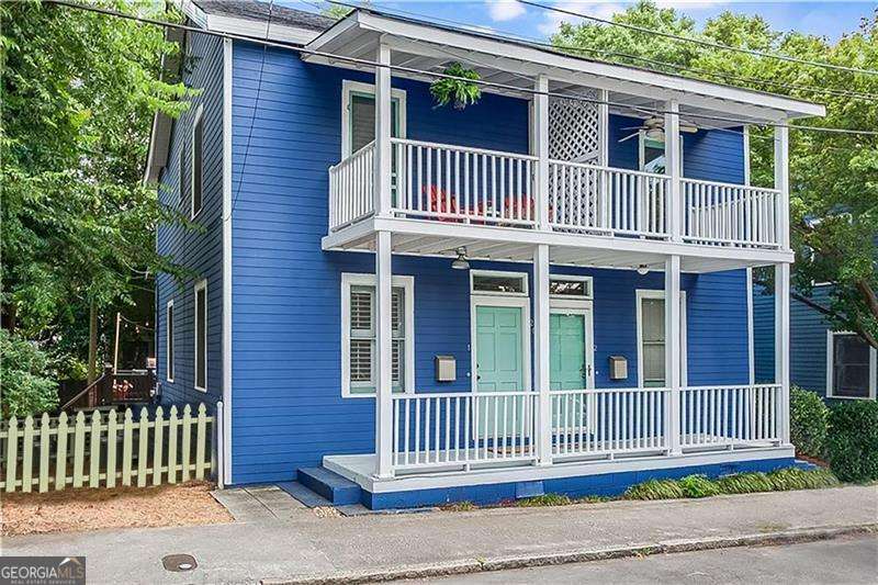 Charming Charleston-style two story historic townhouse Cabbagetown with off-street parking! This fee simple home has no rent restrictions and no HOA and is set on a quiet street right in the heart of historic Cabbagetown. The home blends original early 19th century character with thoughtful updates throughout. The main level features an open kitchen that flows easily into the dining and living areas. Hardwood floors and tall ceilings make the space feel bright and welcoming. Double porches at the front bring in natural light, while a spacious shady back deck creates the perfect spot for relaxing or entertaining. Inside, you'll find generous storage throughout, a renovated bathroom, and two sunny bedrooms upstairs - including one with its own walk-out balcony with city views. A side yard adds even more possibilities for gardening or pets. Amazing price for this location where you're an easy stroll to shops and restaurants on Carroll Street, the Beltline, Grant Park, and Krog Street Market. Perfect for an owner occupant or, for someone looking to invest, short term rentals consistently bring in $3,000-$4,000 per month. Home can be sold furnished.