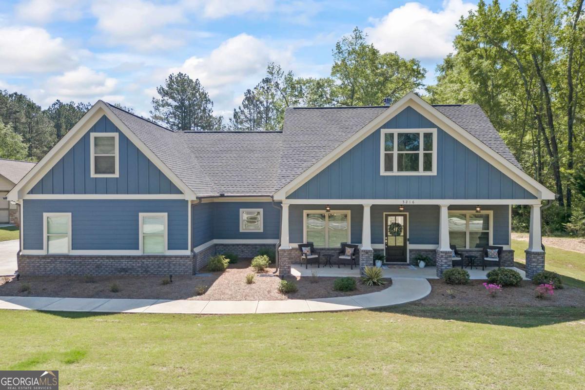 4/3 Ranch with Teen Suite Up with Huge Walk-In Closet. Screened In Rear Porch with Outdoor Fireplace! Conveniently located in Between - Directly Located between Loganville and Monroe. Close to Area Amenities. Highway 78, Community Park & Splash Pad Nearby. Discover timeless charm and modern comfort in this beautifully designed Craftsman-style home. Featuring an open-concept layout with the primary suite on the main level, this 4-bedroom, 3-bathroom home offers both convenience and style in every detail. The spacious master suite is a serene retreat, complete with an elegant spa-like bathroom. A smart split-bedroom floor plan ensures privacy, while the upstairs bonus area can double as a teen suite and also provides a quiet flex space, perfect for a home office or study, gym, or movie room. The heart of the home is the stunning family room with reclaimed mantle, floating shelves and cabinets. The family room flows seamlessly into the gourmet kitchen. Enjoy cooking and gathering with built-in wall oven and microwave, granite island, cooktop, and a cozy breakfast bar. Step outside to your own outdoor sanctuary with an inviting screened-in covered patio with its own fireplace, overlooking a professionally landscaped backyard. An irrigation system keeps everything lush and green, making outdoor living easy and enjoyable. Comfort, style, and functionality come together beautifully in this Craftsman gem. Welcome home!