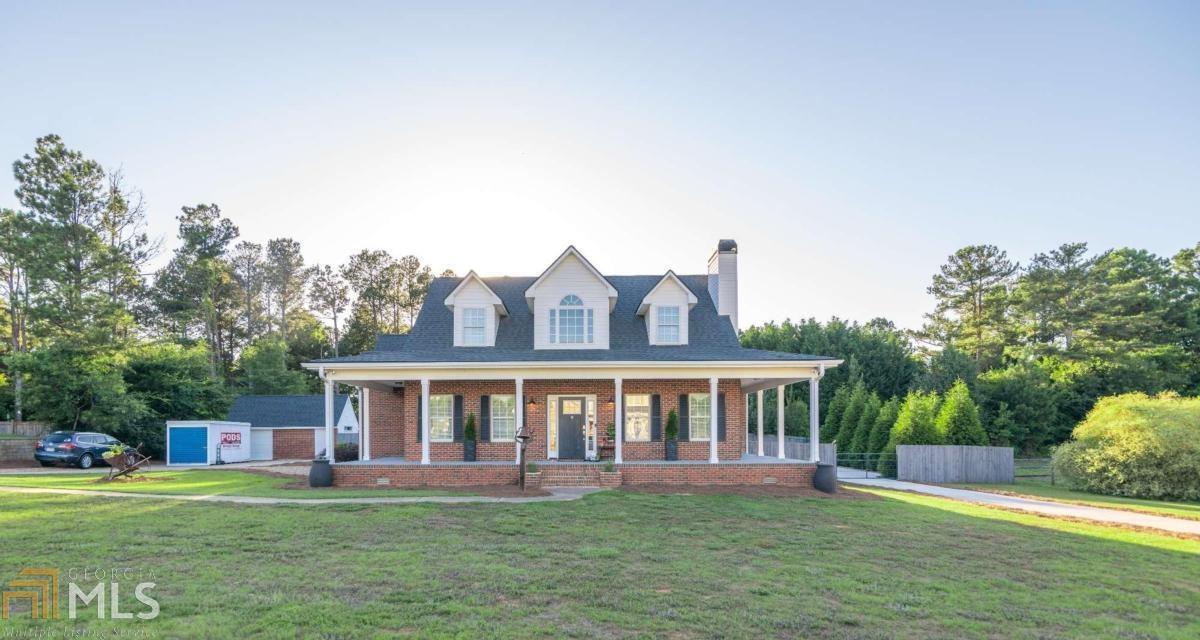 Beautiful 4 sided brick home with 2 driveways, 3 covered porches, fenced in backyard, workshop AND in-law suite. You'll feel right at home as you walk through the front door and notice the heart of pine flooring throughout and the recently painted walls. The kitchen sparkles with updated shaker style cabinets, granite countertops, tile backsplash, farmhouse sink, double ovens, stainless hood vent and 6 barstool island. The antique sliding barn door in the hall hosts a large pantry. Master on main with a beautiful bathroom with a LARGE shower! Two extra spacious bedrooms upstairs and bathroom with walk in tile shower. In-law suite features a full kitchen, living area with Murphy bed, bathroom with walk-in shower, storage area, an additional bedroom and flex area upstairs.