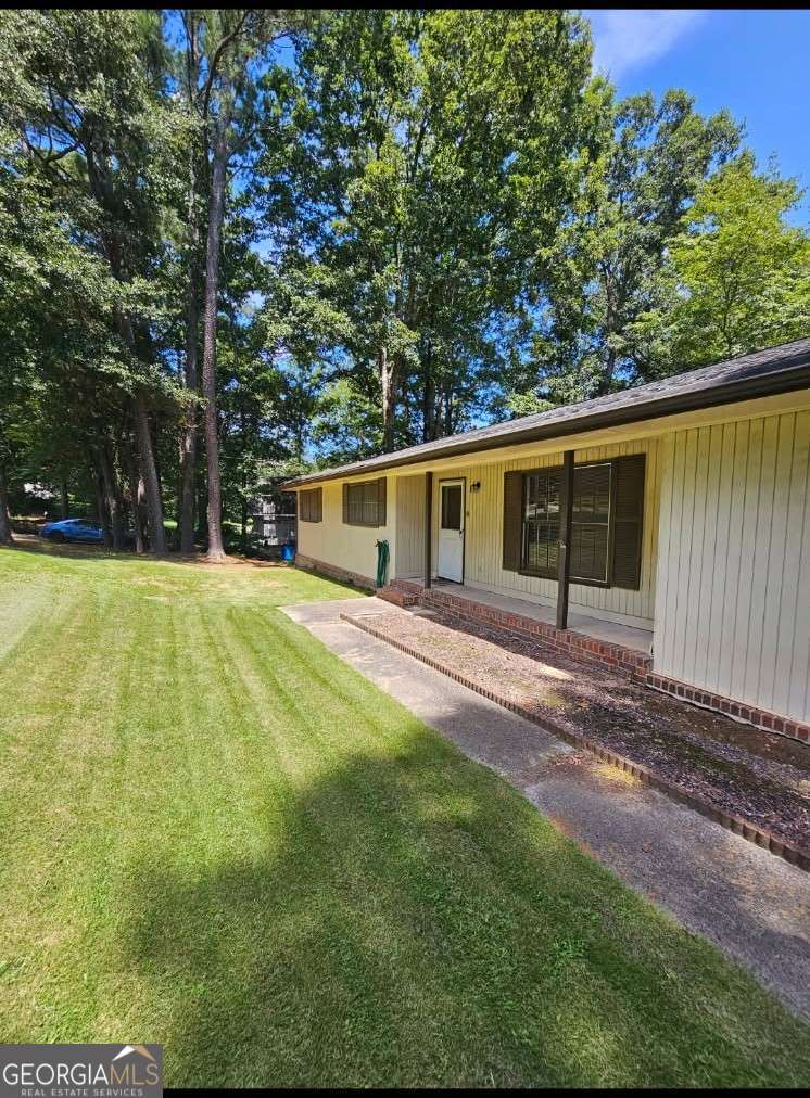 Investor Opportunity! Cash investors-bring your contractor! Home is being sold as-is. Nestled on 1.47 acres, this 3-bedroom, 2-bath ranch is perfectly located just minutes from Snellville, Hwy 124, and Hwy 78. Featuring a bright family room with soaring cathedral ceilings, a white eat-in kitchen, and a spacious deck ideal for entertaining or relaxing, this home offers both comfort and potential. Whether you're looking to invest or create your dream space, don't miss out-more details and additional photos coming soon! Please note, power is currently off.