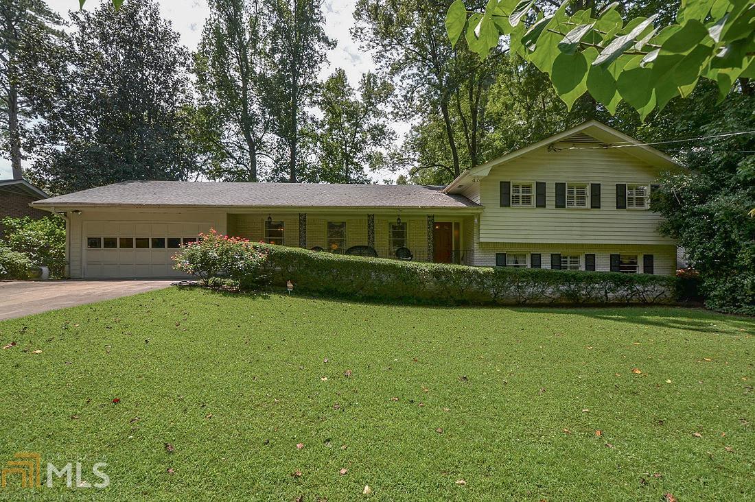 Classic White Brick split level with great backyard. Large rooms, hardwoods, front porch, entry foyer, formal LR/ separate DR. Huge eat in kitchen with separate utilities/storage room. Fireside great room with built-in bookcases. Upper level has three bedrooms and 2 full baths. Lower level with laundry room, bedroom and full bath, media/recreation room with wet bar. Sliding glass door to patio overlooks lush private backyard. Walk to Oak Grove Village Restaurants and shops. Minutes to Emory, CDC, VA Hospital and Downtown Decatur.