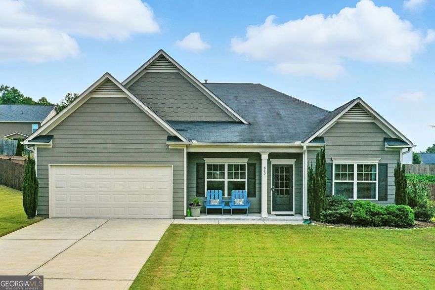 Step inside this thoughtfully maintained ranch-style home, where every detail has been cared for by the original owner. The open-concept layout begins with warm hardwood floors leading through the dining area and into the heart of the home-a bright, welcoming living space anchored by tall windows and a tray ceiling.  The kitchen is designed for daily ease and weekend entertaining, featuring granite countertops, a gas range, and warm wood cabinetry. A spacious island with a deep sink and pull-down faucet adds function and flow, while the adjoining breakfast nook is wrapped in windows, filling the space with natural light.  The primary bedroom offers a quiet place to recharge, with soft carpeting underfoot and tray ceilings above. The en suite bath includes a glass-enclosed shower, dual vanities, and a walk-in closet with plenty of storage. Two secondary bedrooms, each with their own full bath, and an extra half bathroom provide flexibility for guests or home office needs-all tucked conveniently on one level.  Out back, enjoy a covered patio perfect for morning coffee or evening grilling. The fully fenced backyard offers room to play, garden, or simply enjoy a little privacy.  Located near the community swimming pool and park just around the corner, this move-in-ready home puts everything you need within reach-without the hassle.