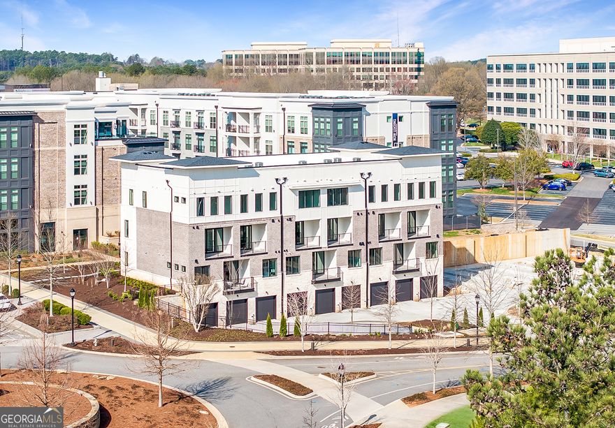 Discover the epitome of modern living in this exquisite end unit stacked floor plan in Monte Hewett's newest neighborhood in Alpharetta Findley Row. This is a true lifestyle opportunity to find your new end unit condominium built by the same builder from Avalon, Halcyon and many other well-known neighborhoods.  Located on the Alpha Loop and a short distance to Avalon, downtown Alpharetta, the North Point district and the Big Creek Greenway, this luxurious home offers the highest end finishes with low maintenance living. The exterior and interior details are just what you will love in Monte Hewett's amazing designs. You will enjoy White Oak Hardwood floors throughout the home, Quartz countertops in the Kitchen and bathrooms, Bell custom cabinetry throughout the home, tile to the ceilings in the bathrooms, custom light fixtures, covered balcony with storage off the rear and front walkout balcony. You will love the main level that has a completely open floor plan from the Family room to the Kitchen and Dining. The Kitchen features a large island with plenty of room for entertainment and great storage space. You will also enjoy the walkout covered patio on the main floor. Upstairs are two generously sized bedrooms with walk-in closets and private baths. The professional design packages are the perfect combinations. The oversize two-car tandem garage offers private and convenient parking with tall ceilings that are perfect for storage and an electric car charger outlet. Crafted by Monte Hewett Homes, known for their quality and attention to detail in nearby Avalon and Halcyon, you will want to come see this home today. Findley Row is located in Northwinds Summit that will feature a hotel, retail, dining and office space, as well as very convenient access to GA-400. Enjoy the Alpharetta location without the local traffic. Contact us to schedule a private showing and experience the exceptional lifestyle you will enjoy in Findley Row!