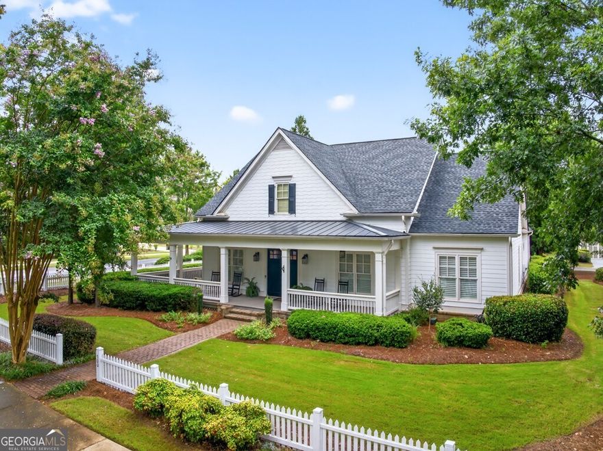 Welcome to this luxuriously upgraded 5-bedroom, 4-bathroom home in the highly sought-after Georgia Club, a gated golf course community known for its Southern charm and resort-style amenities. Situated on a premium corner lot, this beautifully maintained home features a white picket fence, a charming wraparound front porch, and a rear-entry garage, all adding to its curb appeal. Inside, enjoy new flooring, fresh interior and exterior paint, and thoughtful architectural details throughout. The spacious living room features a coffered ceiling, creating a sophisticated and inviting space for gatherings. The kitchen is accented with brick details, blending rustic warmth with modern utility. Perfect for remote work or study, the private office includes custom-built-in shelving. The oversized primary suite is a true retreat, featuring two large custom walk-in closets and a spa-inspired en suite bathroom with a large walk-in shower, double vanities, and elegant finishes. Enjoy year-round efficiency with a solar energy system and keep your landscaping lush with the automated sprinkler system. Located in The Georgia Club, residents have access to world-class amenities: golf, pools, tennis courts, clubhouse, fitness center, and walking trails. This home offers a rare combination of classic Southern charm and modern luxury in one of Georgia's most desirable communities. Seller is offering Buyer a 2-1 Rate Buy Down with acceptable offer. Reach out to Joshua Egnoski to find out how much you can save per month with this fantastic program!