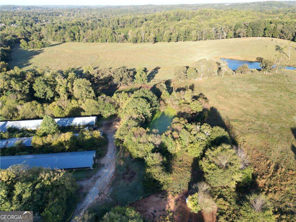 Beautiful! 29 acres of possibility located in Cherokee County! This property has all utilities available. Currently zoned agriculture. There are horse barn and paddock, and chicken houses currently on site. There is a house on the property as well. All these structures can be torn down to fit your needs and vision. Prime location and award winning schools.