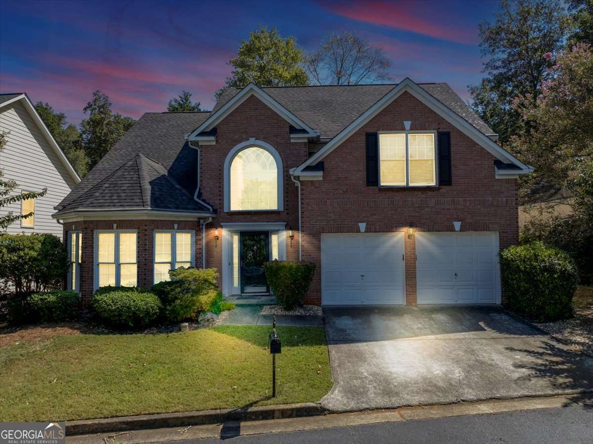 Introducing an exceptional 4-bedroom, 2.5-bath residence with 2,858 sq ft of beautifully designed living space, nestled in a private gated community just minutes from downtown Smyrna and I-285. A dramatic two-story foyer sets the tone, leading to elegant formal living and dining rooms ideal for hosting and special occasions. At the heart of the home, the soaring vaulted great room showcases a striking gas fireplace and opens through French doors to a charming patio and fenced backyard-perfect for effortless indoor-outdoor living. The gourmet kitchen offers abundant cabinetry, a spacious center island with breakfast bar seating, and generous counter space for both everyday meals and entertaining. The main-level owner's suite is a true retreat, featuring a spa-inspired bath with double vanities, soaking tub, separate shower, and a large walk-in closet. Upstairs, three additional bedrooms and a full bath provide comfort and flexibility for family, guests, or a home office. Hardwood flooring enhances the main level, while the low-maintenance yard ensures more time to enjoy the community's peaceful surroundings. Style, comfort, and convenience combine seamlessly in this gated neighborhood, offering easy access to shopping, dining, and major highways.