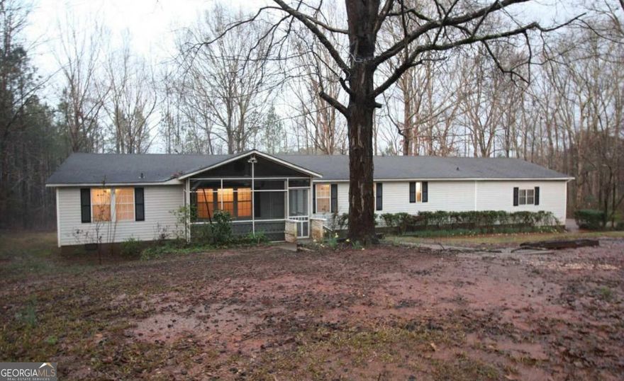 PRIVACY GALORE on 5.74 Acres!  Looking for a peaceful retreat with room to roam? This 3-bedroom, 2.5-bath ranch offers tons of potential for the right renter or future homeowner ready to put in a little work and make it shine again.    Inside, you'll find a spacious, open layout with a large family room overlooking the back deck and private yard, plus a second living area with a fireplace for cozy evenings in. The eat-in kitchen includes built-in seating and plenty of space for updates and personalization.    The primary suite features an oversized bedroom with dual closets and a bath that includes a Jacuzzi tub and separate shower. There's also an attached 2-car carport, laundry/mud room with washer and dryer included, and all the space you need to bring your vision to life.    With a little effort and creativity, this home could easily become your dream retreat. Call today to see the potential!