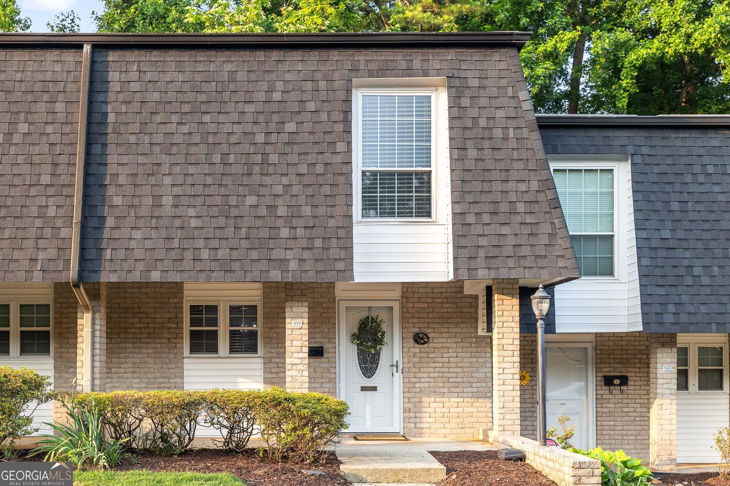 Fantastic in-town Townhome opportunity situated in the highly sought after "Cloisters" community located seconds from Buckhead and Sandy Springs! This elegant 2-bedroom, 2.5-bathroom townhome is a rare find, offering a detached 2-car garage with generous storage which is an uncommon amenity in this prime location. Step inside to an airy, open concept layout. The updated and renovated kitchen is the heart of the home and offers ample cabinetry, fresh stainless-steel appliances and quartz countertops all while overlooking the separate dining room. Retreat to the fireside family room which is a warm, welcoming space complete with built-in bookshelves, a dry bar, and a true wood-burning fireplace that opens to a private patio and turf yard, perfect for relaxing or entertaining. Upstairs, you'll find two spacious bedrooms, each with its own en suite bathroom. The oversized primary suite features fresh carpet, a updated fixtures, dual closets, and a bath with extended vanity and tub/shower combo. The secondary suite includes a vanity area, walk-in shower, updated fixtures, newer carpet and generous closet space. Enjoy the outdoors from your charming covered front porch or unwind in the private backyard. The detached garage adds exceptional value, offering both parking and much-needed storage flexibility. The Cloisters is a well-maintained, sought-after community with a community pool, dog stations, and abundant guest parking. All just minutes from Chastain Park, Sandy Springs City Center, Buckhead, I-285, top-rated restaurants, shopping, and more. A rare opportunity in an unbeatable location; this one is a must-see!