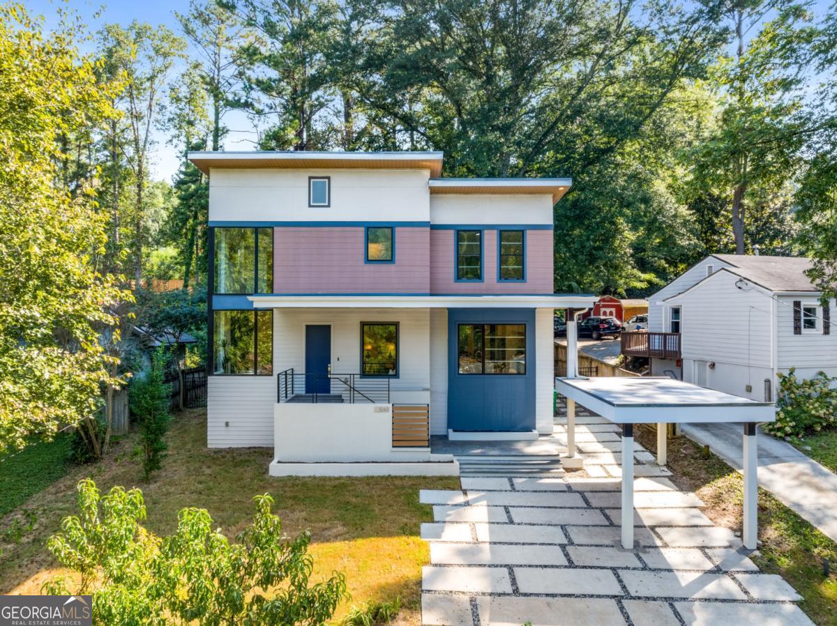 Welcome to this brilliant, one-of-a-kind, California inspired modern home in sought after Woodland Hills, offering timeless design with thoughtful updates and modern conveniences. Built in 2018, the open concept main level is perfect for both entertaining and everyday living, featuring a dramatic living and dining space with a ventless fireplace, custom imported cabinetry, a waterfall quartz island, and premium Bosch appliances. Natural light pours in through oversized commercial windows, highlighting the seamless real white oak hardwoods throughout the home. A versatile main level bedroom with ensuite bath and French doors to the covered porch adds flexibility (and could be used as a primary bedroom on main level) with an extra half bath on main level for guests. Upstairs you will find that the expansive primary suite offers an incredible private balcony, spa bath with soaking tub and dual vanity, and a walk-in closet. Additionally, the upstairs boasts two more spacious bedrooms with jack & jill bath and laundry room. Outdoor living is just as impressive -- in addition to the private balcony off the primary suite, you have a covered porch with hot tub, and a screened in porch for all season use -- thats THREE useable outdoor spaces that seamlessly blend indoor/outdoor living. Additional features include a tankless water heater, solid wood doors, and a carport for convenience. Perfectly positioned near excellent schools, this home also provides easy access to CDC, Emory University, Buckhead, Morningside, retail/dining, and major highways, blending comfort, sophistication, and an unbeatable location. New construction homes selling upwards of $1.5m in this neighborhood, lock in a great deal on this phenomenal house that is only 7 years old!