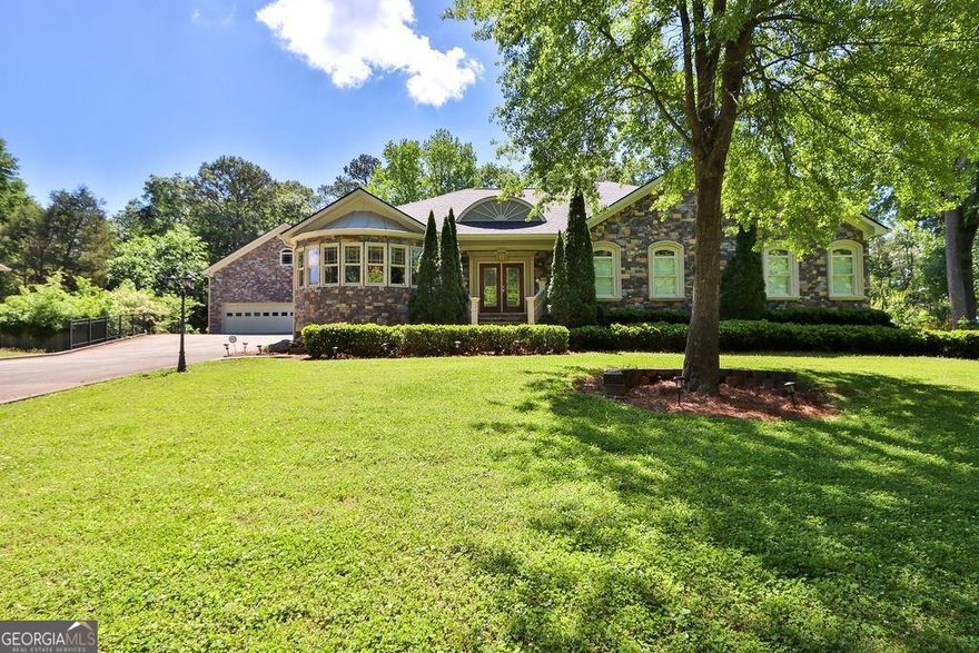 Welcome to this gorgeous one-of-a-kind sprawling ranch home built on a full basement. Completely custom built in 2007, this 4-sided stone masterpiece has been meticulously maintained through the years. Featuring an extensive amount of finished space on the terrace level, and a separate detached 3-story 3-car garage with ample storage space... you won't find another property like this! Recent big-ticket updates include: BRAND NEW ROOF (2023) and TWO BRAND NEW 40-gal WATER HEATERS (2024) w/ NEW RECIRCULATING PUMP. Upon entry, you're greeted with a grand entrance showcasing tons of space and natural light flowing into the home. The entire main level features gorgeous hardwood floors, 3 bedrooms and 2.5 bathrooms. The heart of the home lies in the kitchen, which features custom cabinetry with gorgeous glass fronts, Corian countertops, a double oven, and butlers pantry! With ample storage and prep space, this kitchen is as functional as it is beautiful. The master bedroom features an expansive layout with a separate sitting area, plus his/her closets (one of which is a full cedar closet!). The ensuite bathroom is fully handicap accessible with a huge walk-in shower, claw foot tub, double vanities, and plenty of storage space. The terrace level basement is finished and full of windows! Built-in bookcases decorate most of the walls, suitable for thousands of books! Additionally, 2 additional bedrooms on this lower level share a full bathroom. With a 2nd living room space, plus an additional fireplace, office, and workshop/sewing room - the numerous versatile spaces can be tailored to suit your unique needs. About 400sqft of unfinished space is equipped with plenty of built in storage shelves. Outside, your private backyard features a deck crafted from durable Trek decking plus a fenced-in covered porch area perfect for pets or children. The detached 3-car garage is oversized with ample room for large vehicles, all your motorcycles & toys, etc. The upper level of the garage is an unfinished attic space and the lower level is a single stall garage perfect for a workshop or to store all your lawn mowers, tools, etc. SEPTIC PUMPED 2022. Conveniently located in East Cobb near Roswell Rd with quick access to plenty of shopping, dining, and interstates. Welcome Home!