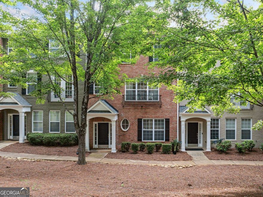 Welcome to this beautifully renovated townhome in a prime Alpharetta location just 1.6 miles from downtown and only 2 miles from The Avalon. Experience the best of North Fulton living! You're just minutes away from Ameris Bank Amphitheatre, North Point Mall, great schools, dining, and parks. This home blends modern design with everyday comfort in a vibrant and sought-after community.  Step inside to see a main level with an open concept. The kitchen has a stunning quartz center island with a waterfall edge. It also features updated cabinetry and custom lighting. The spacious dining area flows into the living room, perfect for hosting and relaxing. The handy powder room and game closet add practicality. The balcony off the living room is perfect for morning coffee or evening barbecues.  The current homeowner has made many updates. They replaced the flooring with luxury options and removed all carpet. They added designer lighting fixtures and custom accent walls that bring texture and charm. The upstairs owner suite feels like a private getaway. It has a spa-like bathroom with a soaking tub, dual vanities, and a separate shower. Plus, there's a custom closet system for great organization.  Two additional bedrooms upstairs provide generous space and storage. The terrace level features a fourth bedroom or flexible bonus space with its own full bath, ideal for guests, a home office, or media room.  This townhome is ready for you to move in. It features low-maintenance living and upscale finishes. Plus, it's in one of the most sought-after areas of Alpharetta. Whether you are looking for a stylish place to entertain or a peaceful place to unwind, this home has it all.