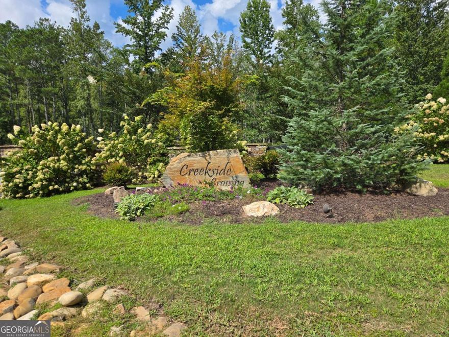Beautiful Corner Lot in Creekside Crossing Subdivision Gilmer County.  Creekside Crossing, one of Gilmer County's newest and most desirable communities! This stunning corner lot offers the perfect blend of convenience, natural beauty, and community amenities. Located just off Hwy 136, you'll enjoy paved roads throughout the subdivision along with access to a gorgeous clubhouse and an infinity pool overlooking majestic mountain views. The neighborhood also features a creekside park with picnic pavilion and fire pits, plus nature preserves with hiking trails that lead to serene creekside areas. Perfectly situated, you'll be only minutes from Ellijay, Jasper, and Chatsworth and just 5 minutes to Carters Lake Marina for endless outdoor recreation. The lot itself is located gently off the road, creating an ideal spot for your future home. Beyond the build area, the property slopes down to a peaceful small creek, where you could add steps or a trail to create your own private retreat. Don't miss the chance to build your dream home in this sought-after community where mountain views, creekside tranquility, and modern comforts come together.  Seller is willing to consider owner financing, subject to buyer approval of terms.