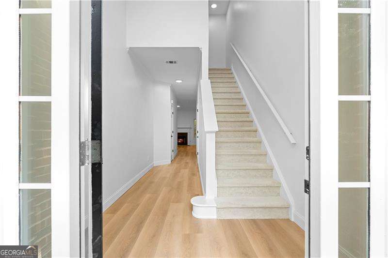 Where Luxury Meets Modern Elegance Welcome to this beautifully renovated 3-bedroom, 2.5-bath end-unit townhouse, where timeless design meets contemporary comfort. Featuring a striking brick-front exterior, this home has been completely transformed to offer luxurious, low-maintenance living. Step inside to soaring ceilings and an abundance of natural light that immediately elevate the space. Newly installed luxury vinyl plank (LVP) flooring flows seamlessly throughout both levels, adding warmth and sophistication. The fully updated kitchen is a true showpiece-complete with modern stainless steel appliances, designer cabinetry, and sleek finishes that will inspire your inner chef. Upstairs, you'll find spa-like bathrooms with large, custom-installed porcelain tiles that create a refined, retreat-like atmosphere. Every detail of this home has been thoughtfully curated-from the open layout to the upscale finishes-offering move-in ready ease in a truly elevated setting. Don't miss this rare opportunity to own a fully renovated home that effortlessly blends style, space, and function.