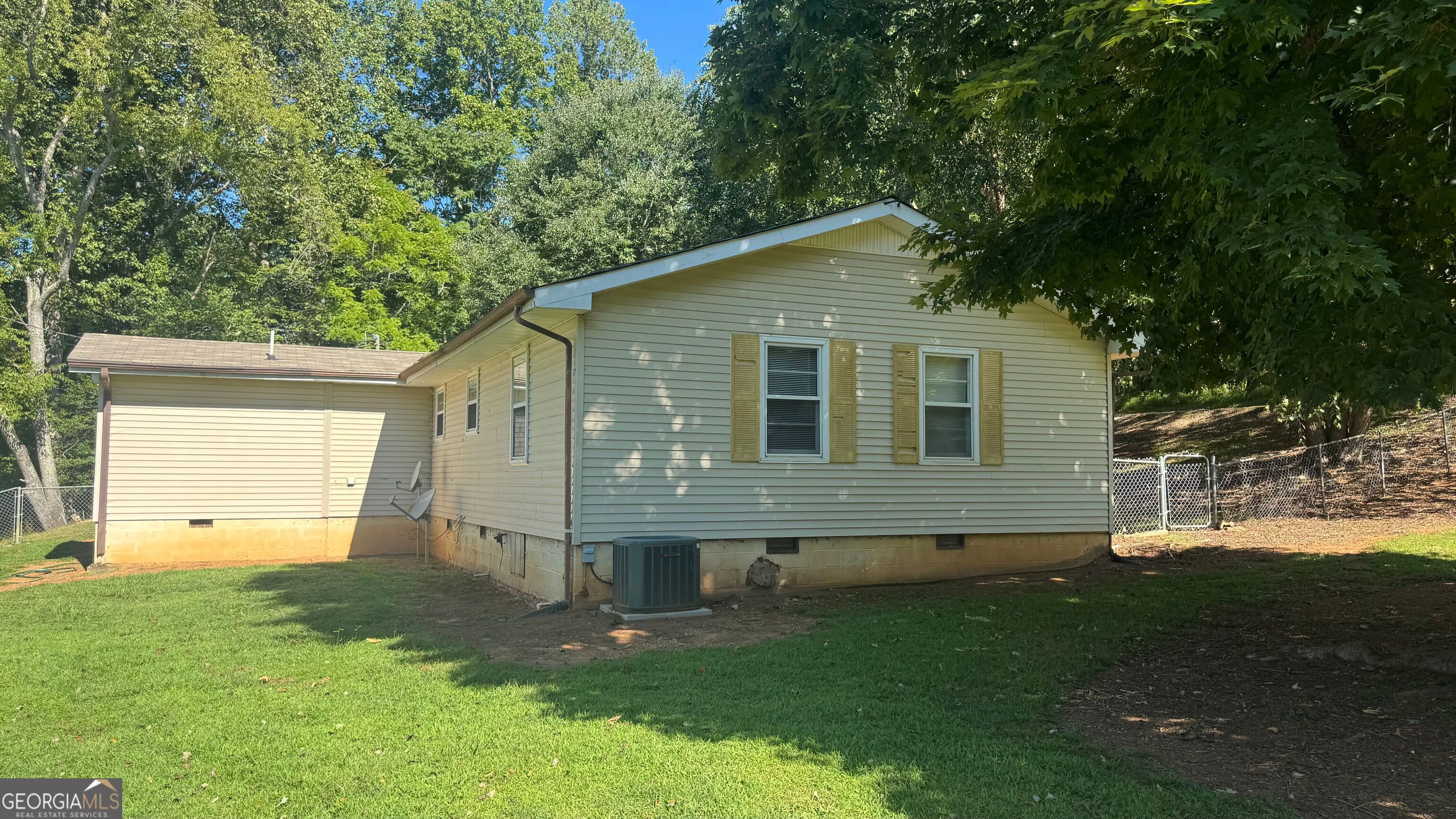 This 3 bedroom/2 bath home offers the perfect opportunity to settle in beautiful Hiawassee. Situated on a flat, usable lot, the property features two driveways and three versatile sheds-one of which includes a concrete floor, garage door, and loft, offering potential for conversion into a guest suite, workshop, or studio. Home is connected to county water, with a private well available for future use if you want. Conveniently located just 5 minutes from downtown Hiawassee and under 10 minutes to Young Harris, this property combines comfort, accessibility, and your next getaway to the mountains!