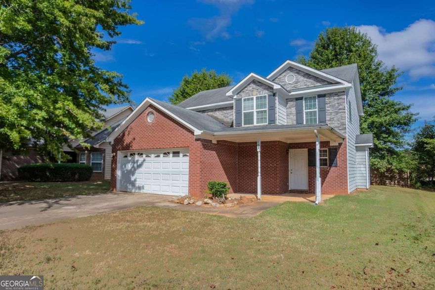 This 2-story home features 3 bedrooms, 2.5 bathrooms, a 2-car garage, and a charming front porch. Inside, you'll find a spacious living room with a cozy fireplace and a primary bathroom with a double vanity, separate tub, and shower. Please note: the home requires significant rehab-flooring has been removed down to the slab, some walls and ceilings are exposed to the wood framing. Toilets are not connected to water supply. This property presents a great opportunity for renovation or investment, offering the chance to fully customize and restore the home to your taste. Schedule your showing today and explore the potential!