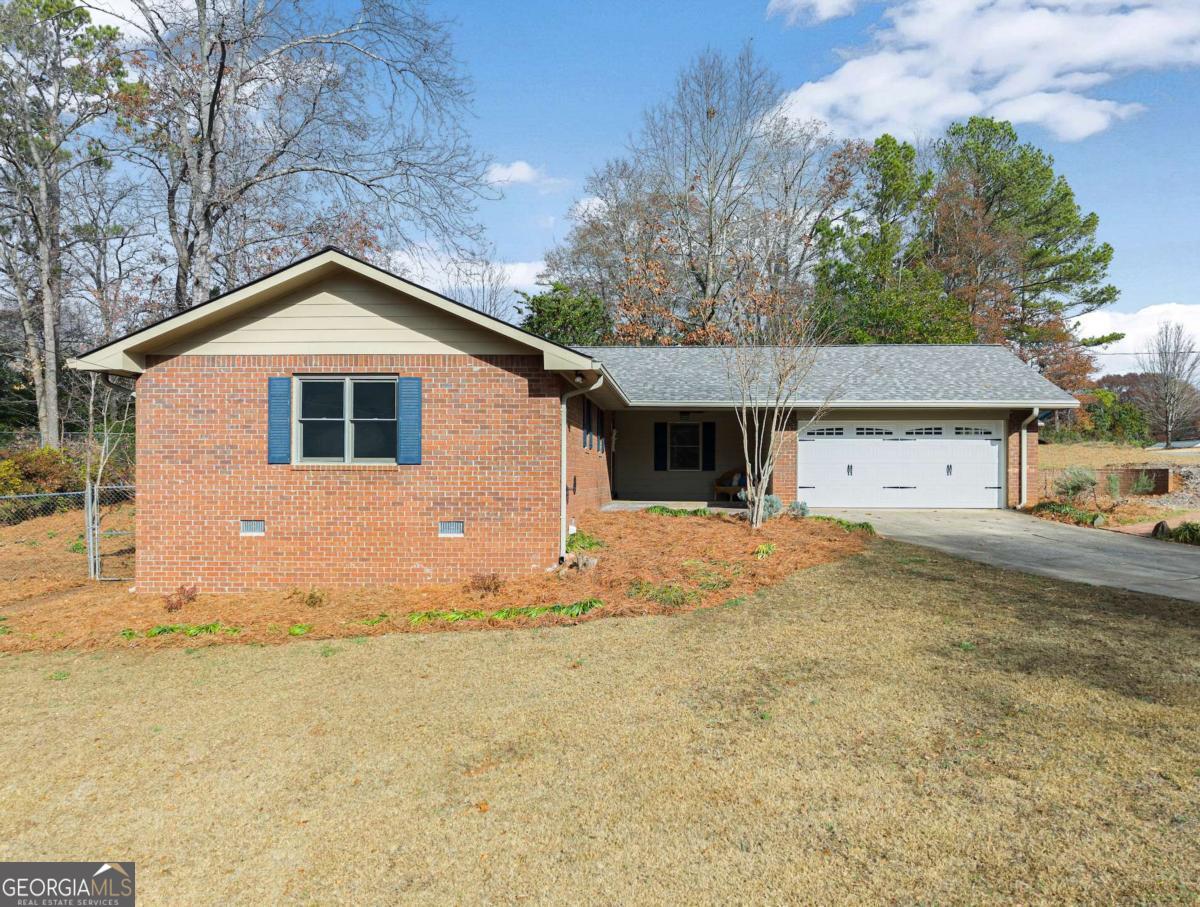 Nestled in a quiet cul-de-sac in the heart of Roswell, this charming 4-sided brick ranch offers unbeatable value under $500K. Boasting 3 bedrooms and 2 baths, this home effortlessly combines stylish updates with timeless appeal. Step inside to gleaming hardwood floors and an inviting open-concept living and dining area. A cozy brick fireplace provides warmth and character, while large picture windows flood the space with natural light. The kitchen is a chefCOs delight, featuring stainless steel appliances, granite countertops, and a subway tile backsplash. A spacious walk-in pantry and laundry room offer exceptional storage. The attached two-car garage provides easy access to the kitchen, making unloading groceries a breeze. Retreat to the vaulted and spacious master bedroom, offering a serene escape with ample room for relaxation. Bask in the privacy of the screened rear patio, perfect for enjoying a good book or hosting gatherings. This beautiful home is ideally located minutes from historic Roswell, Canton Street, Grimes Bridge Park, and top-rated dining and award-winning schools. Plus, with quick access to HWY 400, you're connected to everything the area has to offer. The Sellers have completed significant upgrades, including a NEW ROOF (with warranty), NEW HVAC, and ALL NEW CARPET, ensuring a move-in-ready experience. With no HOA but a true neighborhood feel, 245 Mansell Circle is the perfect place to call home. DonCOt miss this incredible opportunity!