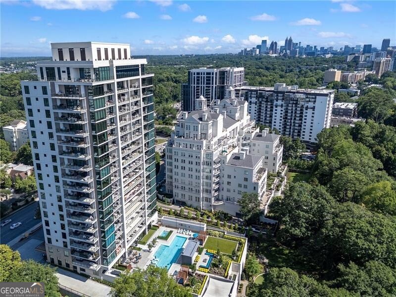 NEW LISTING!! SOUGHT AFTER WEST FACING RESIDENCE available in prestigious Graydon Buckhead. This state-of-the-art boutique building boasts exquisite design, meticulous finishes, and resort-style amenities. Upon entry you are greeted with JAW DROPPING CANOPY VIEWS, the foyer welcomes you with 10' ceilings and unobstructed views from the oversized family room. The open floor plan seamlessly combines the living, dining, and kitchen areas, creating a spacious and inviting atmosphere. Expansive floor-to-ceiling windows allow natural light to flood the space, overlooking the surrounding greenery, and amenity plaza. The gourmet kitchen is a chef's dream, equipped with SUB-ZERO, ASKO and WOLF stainless steel appliances, including a professional-grade gas cooktop, double ovens, SUB ZERO refrigerator and freezer columns, and under counter two SUB ZERO beverage coolers. The kitchen features custom cabinetry, MARMI marble waterfall island, MATTHEW QUINN hardware and a large center island with seating for four to complete the luxurious aesthetic. The SPACIOUS 50' PRIVATE OUTDOOR TERRACE features a built-in Al Fresco Gas Grill with powder-coated cabinets and Dekton countertops. This spacious layout accommodates large scale furniture and complete with FRANCOIS fireplace and television set up for the perfect outdoor getaway. The Owner's Suite exudes tranquility and sophistication. The en-suite bathroom boasts a spa-like ambiance, featuring a soaking tub, a zero-entry glass-enclosed shower, dual marble vanities by MARMI with sleek fixtures, and a spa glass water closet, HOLLY HUNT wallpaper , MATTHEW QUINN hardware with Toto fixtures. His/ her walk-in closet with custom built-ins provides ample space for all your wardrobe needs. The secondary bedroom is equally well-appointed, with ensuite bath, large walk-in closet and private access to covered terrace space. The ensuite bath is equipped with Grohe fixtures, zero-entry floor-to-ceiling tile, and quartz counters. The private den area/ 3rd bedroom is complete with floor to ceiling built-in cabinets and 3rd ensuite bath with SCHUMACHER wallpaper, Toto and Grohe fixtures. The Laundry Room deserves a moment... with quartz counters, built-in sink, front load washer and dryer with pedestals, MAYA ROMANOFF wallpaper, designer lighting and MATTHEW QUINN hardware makes doing laundry a dream! Beyond the interior, this luxury condo offers a range of amenities that enhance the residents' lifestyle. A fully equipped fitness center, private spa room, infrared sauna, full-size swimming pool with lap lanes, jacuzzi spa, club room, four private cabana spaces, two furnished guest suites, private dining area/conference room with A/V perfect for offsite business gatherings. The building also features valet, and 24/7 concierge service, ensuring the utmost convenience for its residents. The private pet park is a haven for our four-legged friends and their owners. THE LARGEST CONDO Dog Park in Atlanta is completely enclosed and features outdoor turf, several seating benches, bagging stations, and leads to covered Doggy Spa. One of the most enticing features of this location is the proximity to the best restaurants and shopping destinations. Just steps away residents can explore a variety of world-class dining options ranging from top-rated restaurants to trendy cafes and bistros. Additionally, renowned shopping at The Shops of Buckhead, ADAC, and Peachtree Battle are within walking distance offering an array of high-end boutiques, department stores, and specialty shops. The Graydon represents the epitome of refined living and offers an extraordinary living experience that combines sophistication, comfort, and convenience. Total square footage includes Large exterior terrace of 576 sq ft. RESIDENCE INCLUDES TWO PARKING SPACES W/EV CHARGER CAPABILITIES, and 1 STORAGE UNIT.