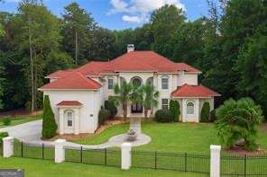 Prime location! Rare opportunity in Fayette County! There is no competition when it comes to this custom Mediterranean style estate home in the beautiful gated well maintained Legacy Hills Community. This resort-like oasis comes with all the bells and whistles: professional landscaping featuring palm trees, in-ground pool, jacuzzi for chilly evenings or relaxing refreshing nights, outdoor kitchen, 2 balconies, and a custom basketball court. This beauty sits on a corner lot and is in the cul de sac to give you the privacy you can appreciate. It has a grand entrance that opens up to views of the 1.2 acre lot. The great room is complete with a double sided fireplace and hugh windows showcasing tranquil views and natural light. The owner's suite is located on the main level and features a fireplace and private balcony with backyard views. Enjoy the classy and newly renovated primary bathroom that has a separate garden tub and an over-sized shower with must see special features, double vanities, and his and her walk-in closets. You will appreciate the office or nursery right outside primary suite for your convenience. The main level has a keeping room and sunroom with access to another balcony that allows you to enjoy breakfast or fancy dinners. Upstairs is loaded with 5 spacious bedrooms including an oversized teen/guest suite displaying a walk-in closet. This layout flows seamlessly into the basement which offers a huge theater room with 12-plus seating, bring your pool table and other games to create a very entertaining recreational area, room for a fish tank, and feel free to display pictures and trophies or your own personal hall of fame, work out in a space for an office and studio set-up. You are minutes from the Hartsfield Jackson International airport, restaurants, and shopping. Trilith Studios is also in the close vicinity offering food and entertainment and it is conveniently located to Woodward Academy and the interstate. *** This property is also listed for sale***.