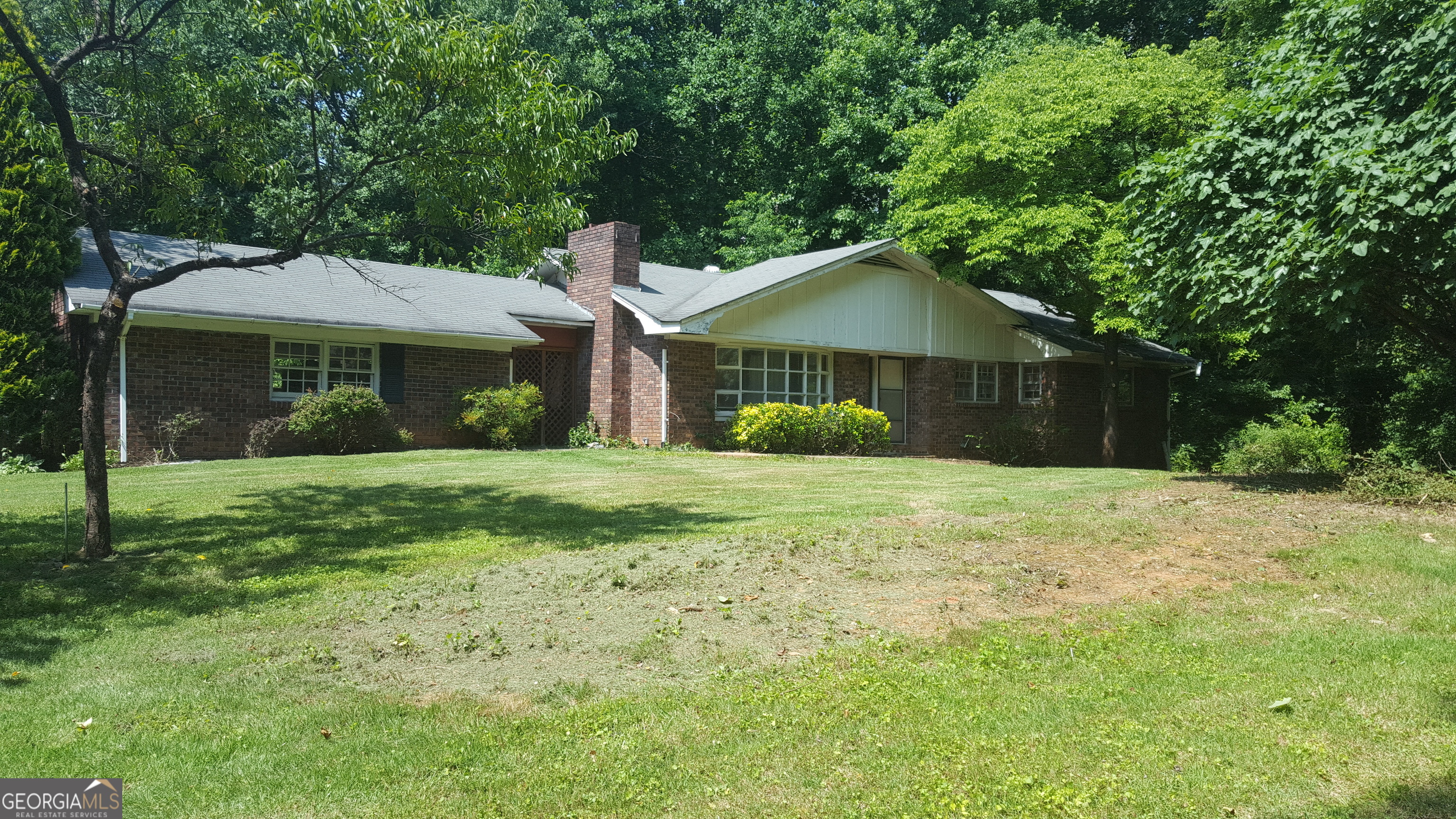 Awesome Opportunity!! This Property is for you! If you are seeking a beautiful piece of land for your personal home or wanting to renovate! Remodel or Build your dream home this home fits the bill! 4 sided brick ranch with Basement. The Home features a spacious eat in kitchen/dining room that flowes to the family room with large brick fireplace! Home is on the sewer line so it could be connected to county water to get rid of well easily. Original Hardwood Floors throughout. This wonderful private home is nestled on 2.3 acres in well established East Cobb! Creek on property. This will not last long! Sold "As Is".