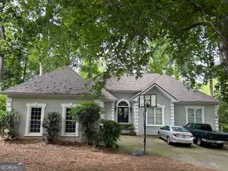 Located in the sought-after school districts of Crabapple Crossing Elementary, Northwestern Middle, and Milton High School, this home checks every box for location and potential. With 5 large bedrooms, and 3.5 baths, this home offers incredible space and versatility. The open layout, high ceilings, and new flooring throughout the main level creates an inviting atmosphere, perfect for everyday living or entertaining. Laundry room off the kitchen for convenience This spacious ranch-style home is being sold as is, providing a unique opportunity to own a well-loved home in one of Alpharetta's most desirable and walkable neighborhoods - just a short walk away from Crabapple Market! Enjoy: A new roof (2024), Newer gas water heater, A finished basement for added living space,Gas fireplace for cozy nights. Plantation shutters and oversized windows that flood the home with natural light. Also, there is a large outdoor deck great for entertaining