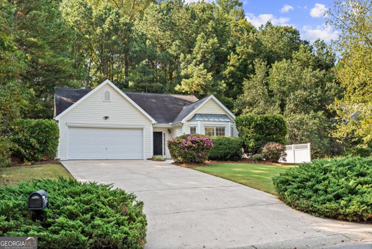 ADORABLE 3 BEDROOM RANCH ON LARGE LOT IN GREAT SOUTH FORSYTH LOCATION NEAR SCHOOLS, CUMMING CITY CENTER, GREENWAY AND EASY ACCESS TO GA 400! NO HOA! Freshly painted and well maintained with newer roof, HVAC and water heater. Open concept floor plan with vaulted family room with gas fireplace, and dining area. Kitchen has view to family room and dining. Primary bedroom is vaulted and has ensuite bath. It is separated from secondary bedrooms. Walk out from main level to sunroom with private backyard. Attached 2 car garage and plenty of parking in driveway. Quiet established community. Walkable to new elementary school. This is a great value on a sought after ranch! Hurry!